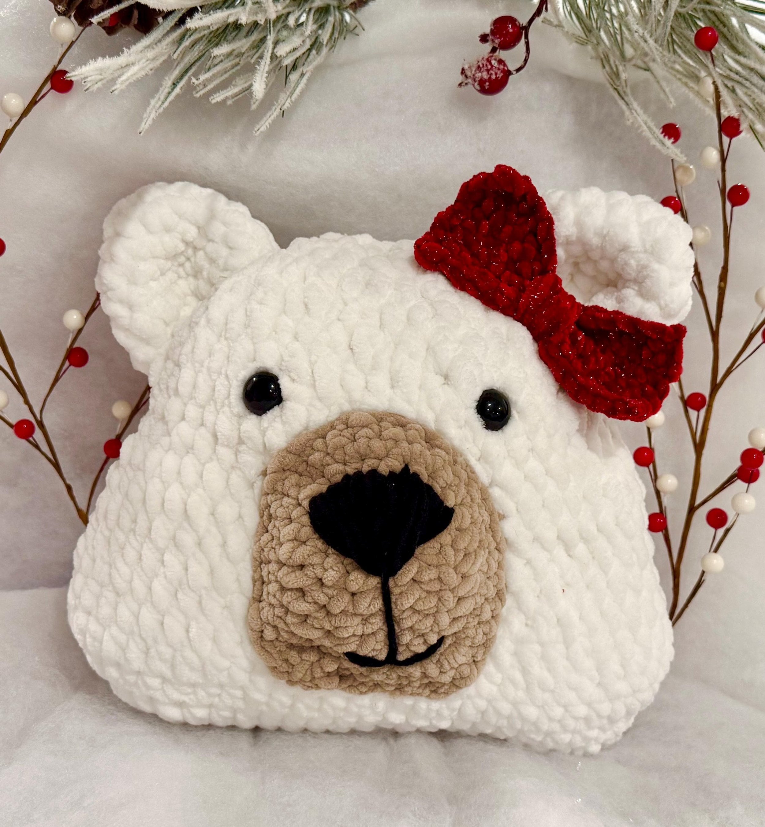 Soft and cuddly handmade crochet bear pillow with a bow, perfect for snuggling.