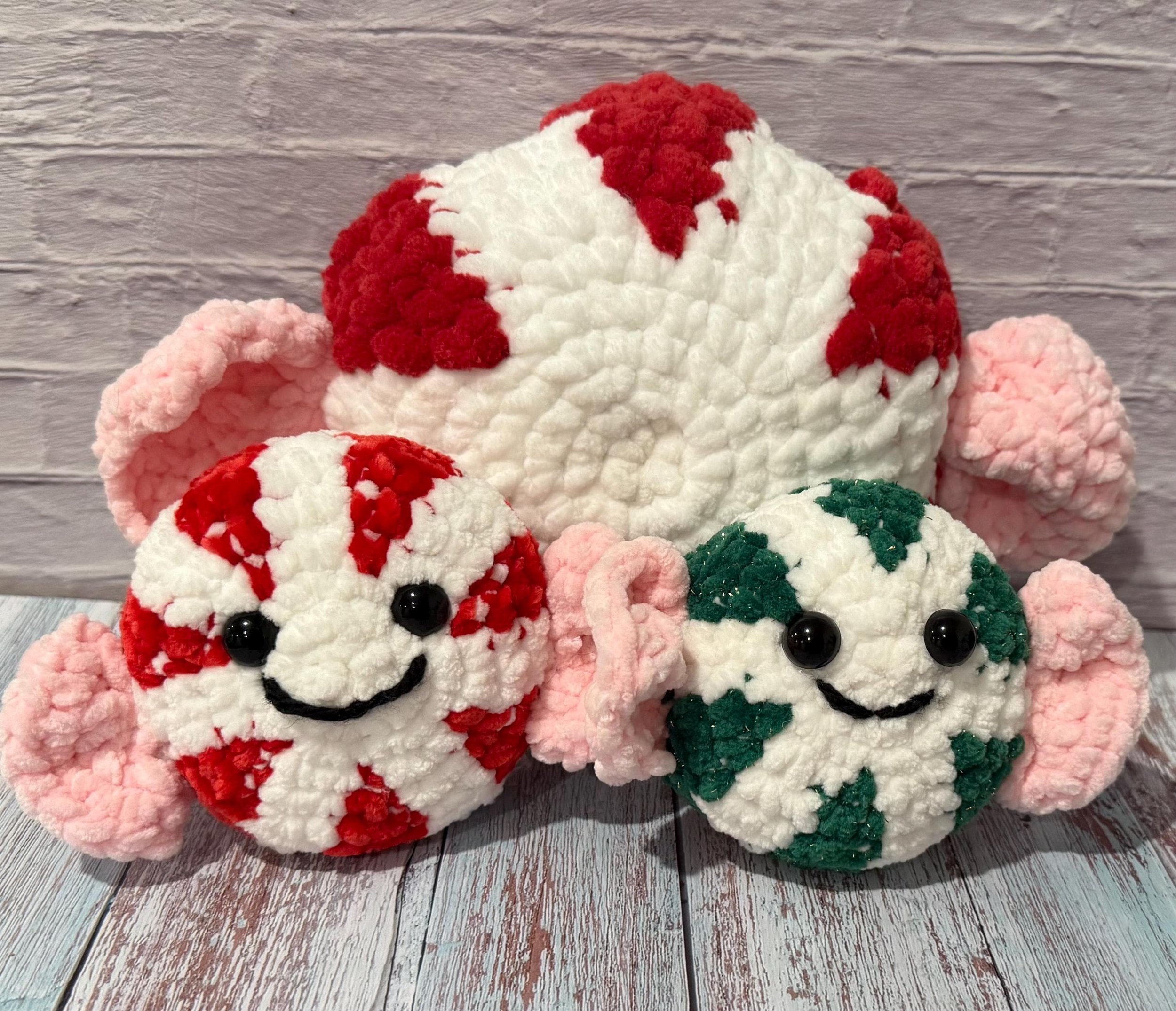 Handmade crochet peppermint-themed pillow set, a sweet touch for holiday decor.