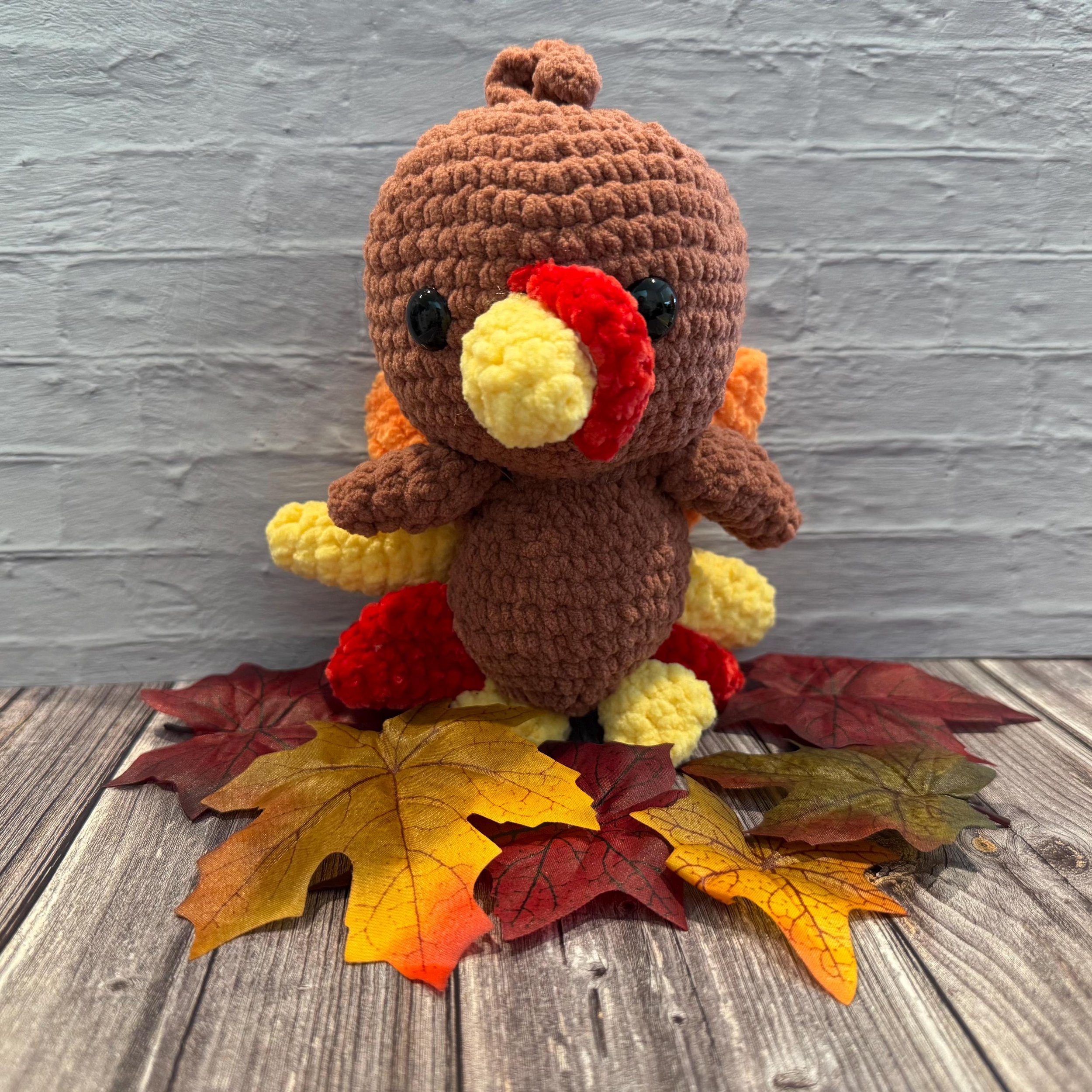 Handmade crochet turkey plushie, a fun and festive Thanksgiving decoration.