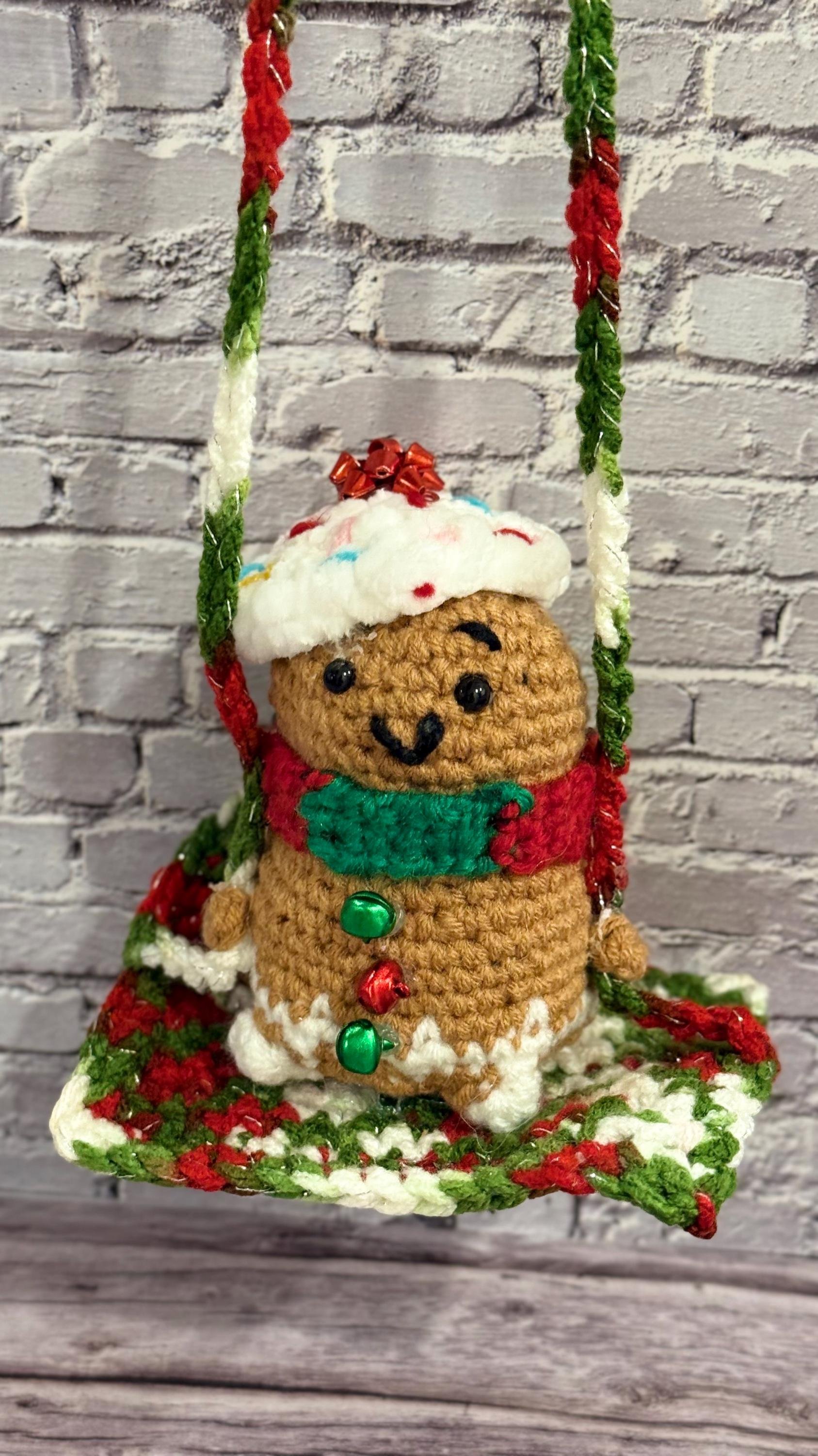 Festive handmade crochet car swing featuring adorable holiday characters for a fun ride.