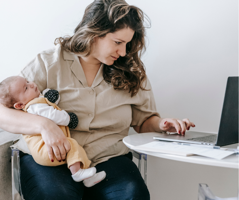 Mother sitting with a journal while planning for postpartum recovery.