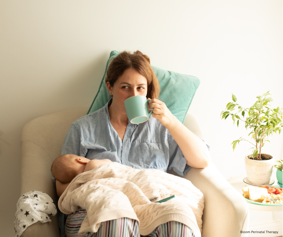 Mother holding her newborn while receiving support during postpartum recovery.