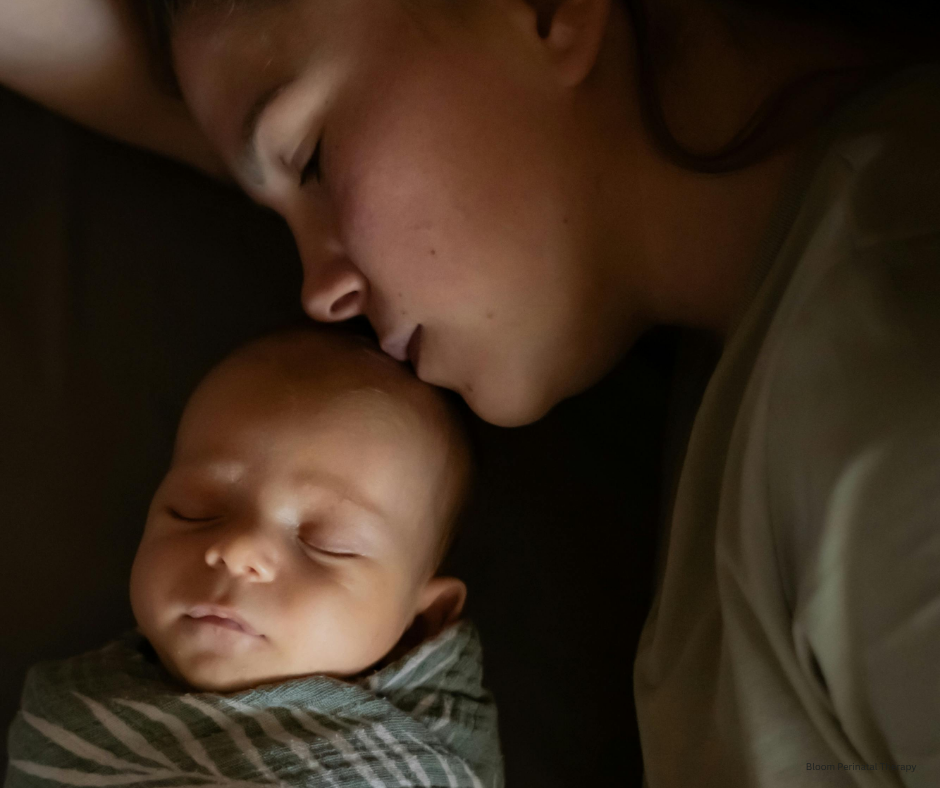 Postpartum mom scrolling social media at night while unable to sleep