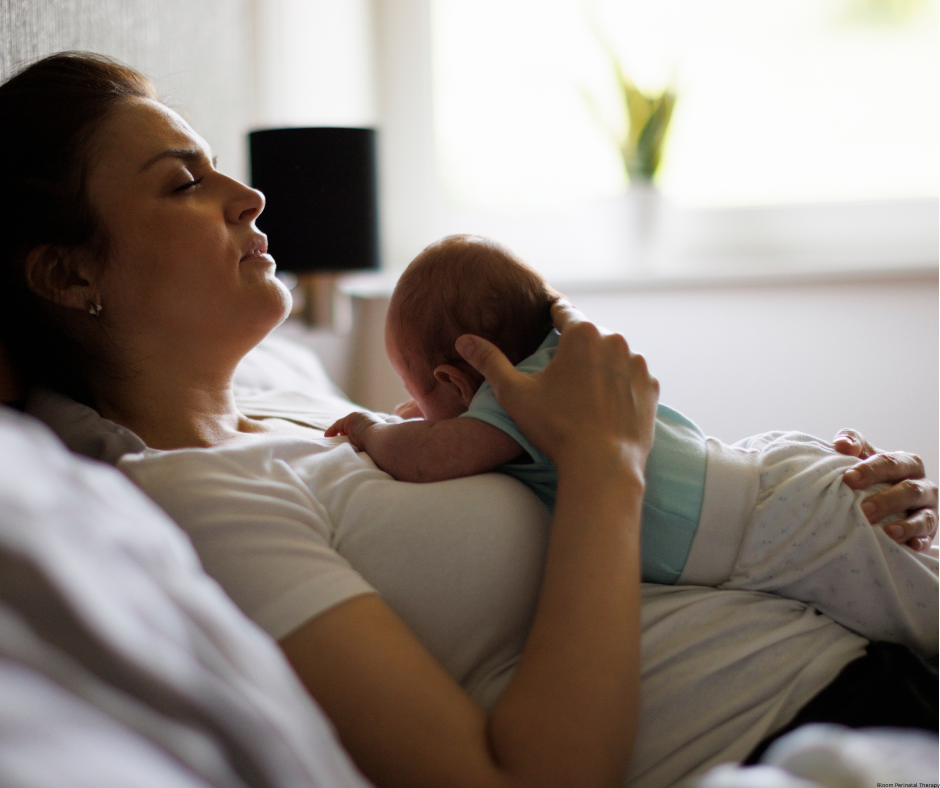New mother holding her baby while experiencing emotional distress after childbirth