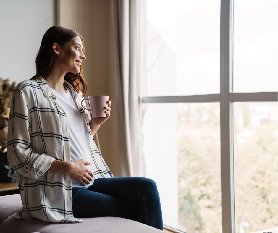 Mother navigating pregnancy and postpartum while receiving compassionate online therapy.