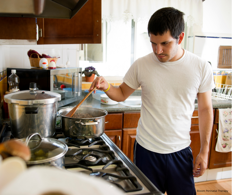 Dad cooks a meal while mom rests after childbirth.