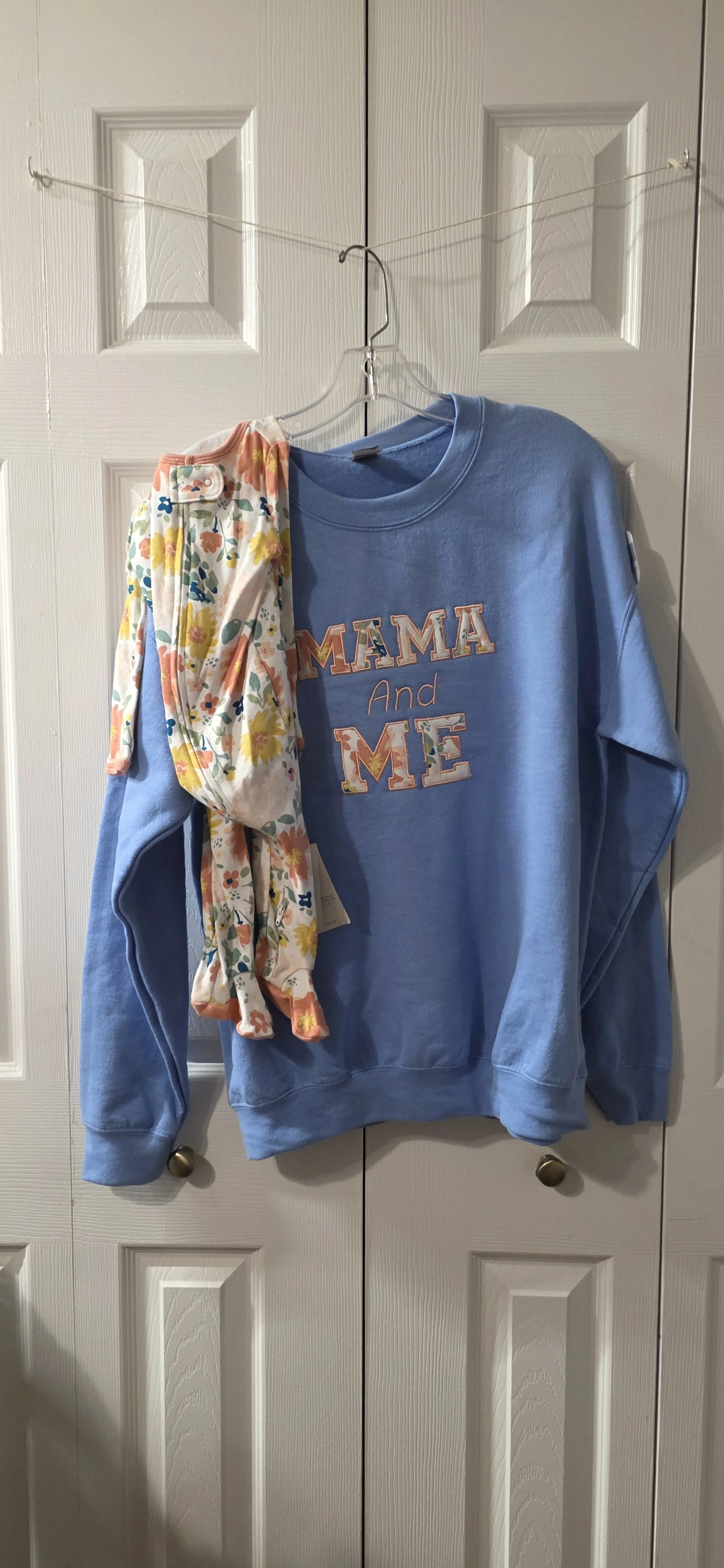 Blue embroidred sweatshirt appliqued with your baby's onsie.  Size med.