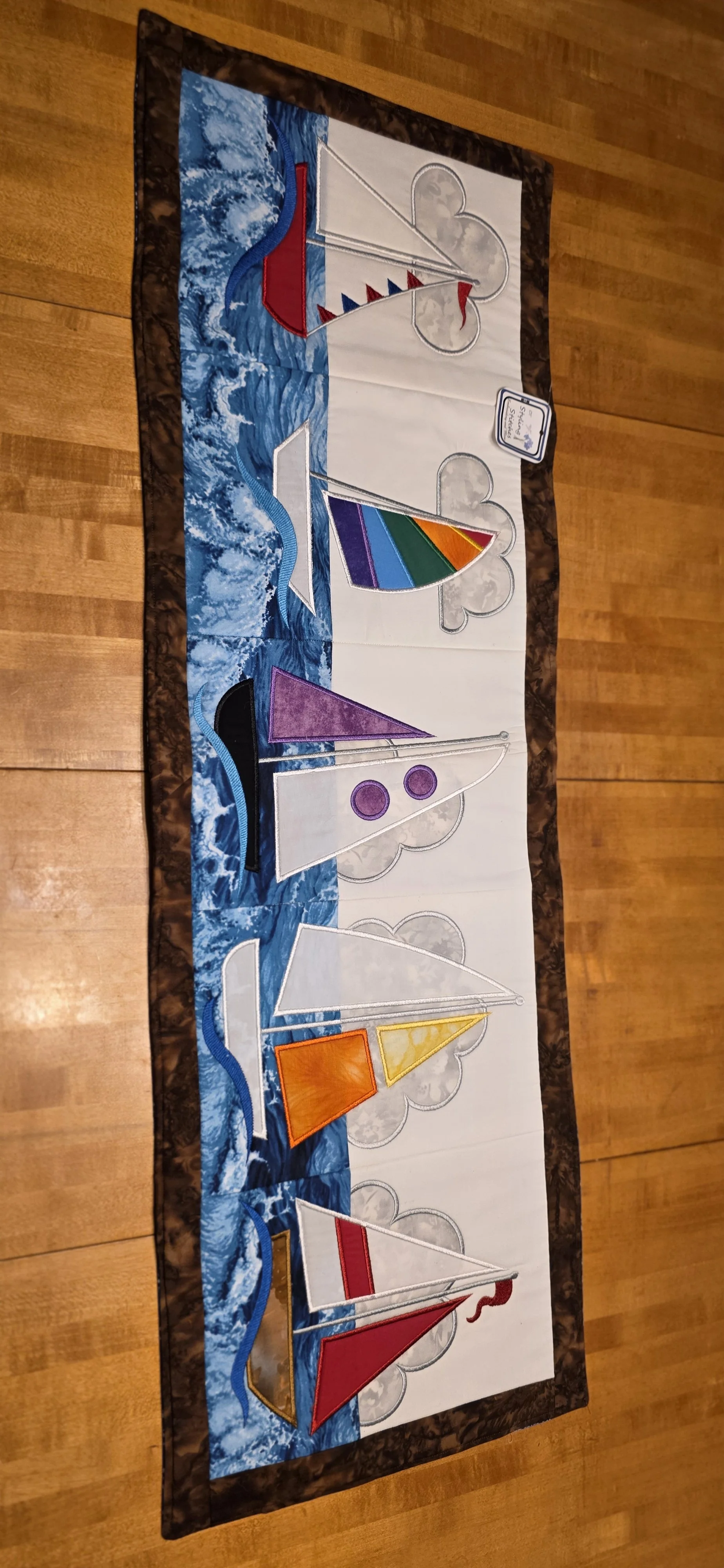 Embroidered 5 sailboat panel with brownboarder with versersiable blue              backing 15x40