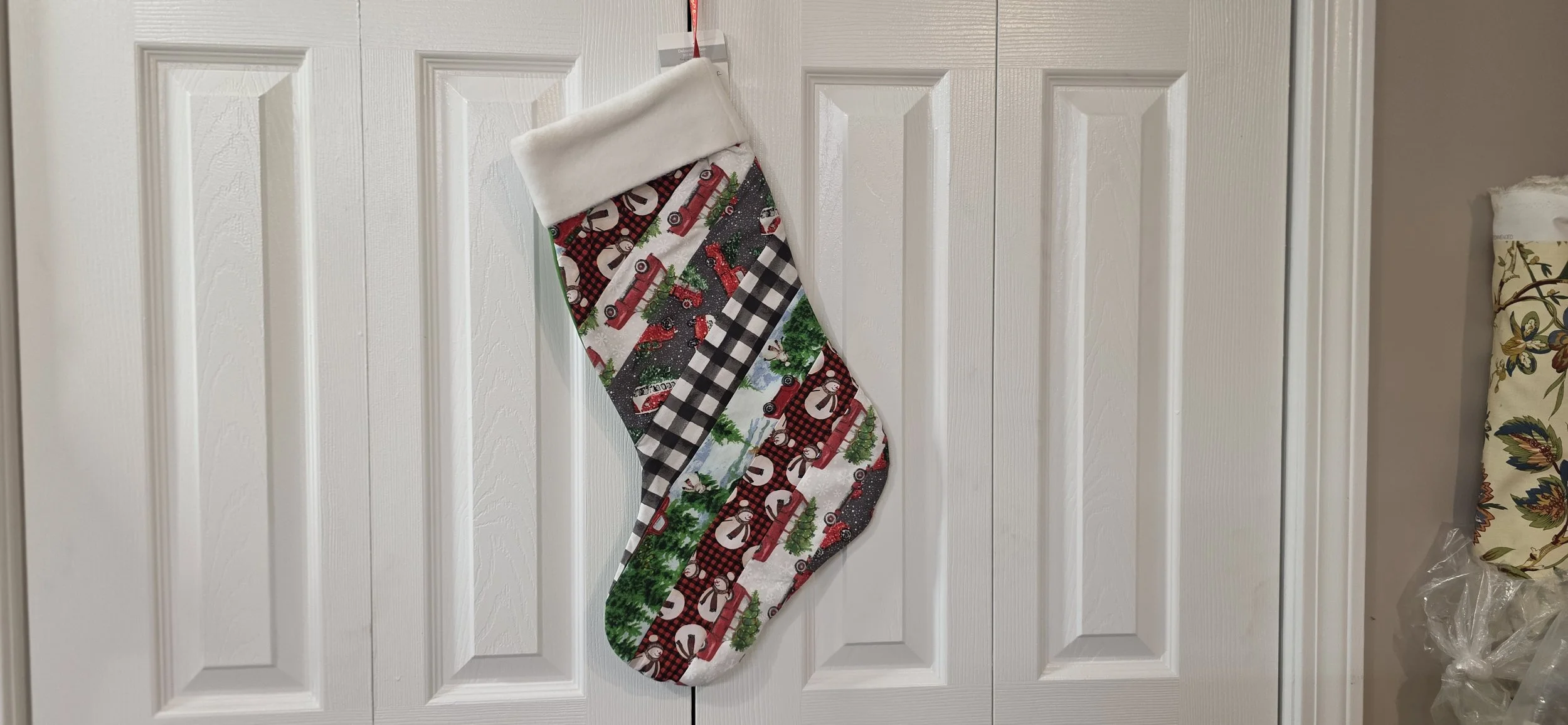 Jelly roll stocking with green back. Hangs in the left direction