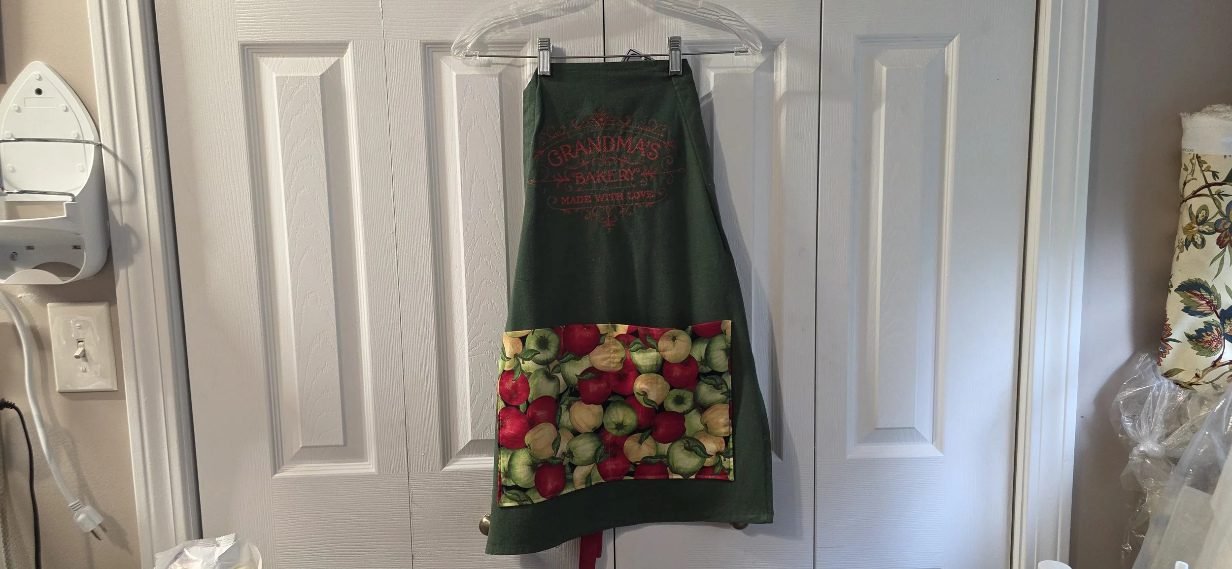 Adjustable tea towel apron. Emproidered with Grandma's Bakery with apple pocket