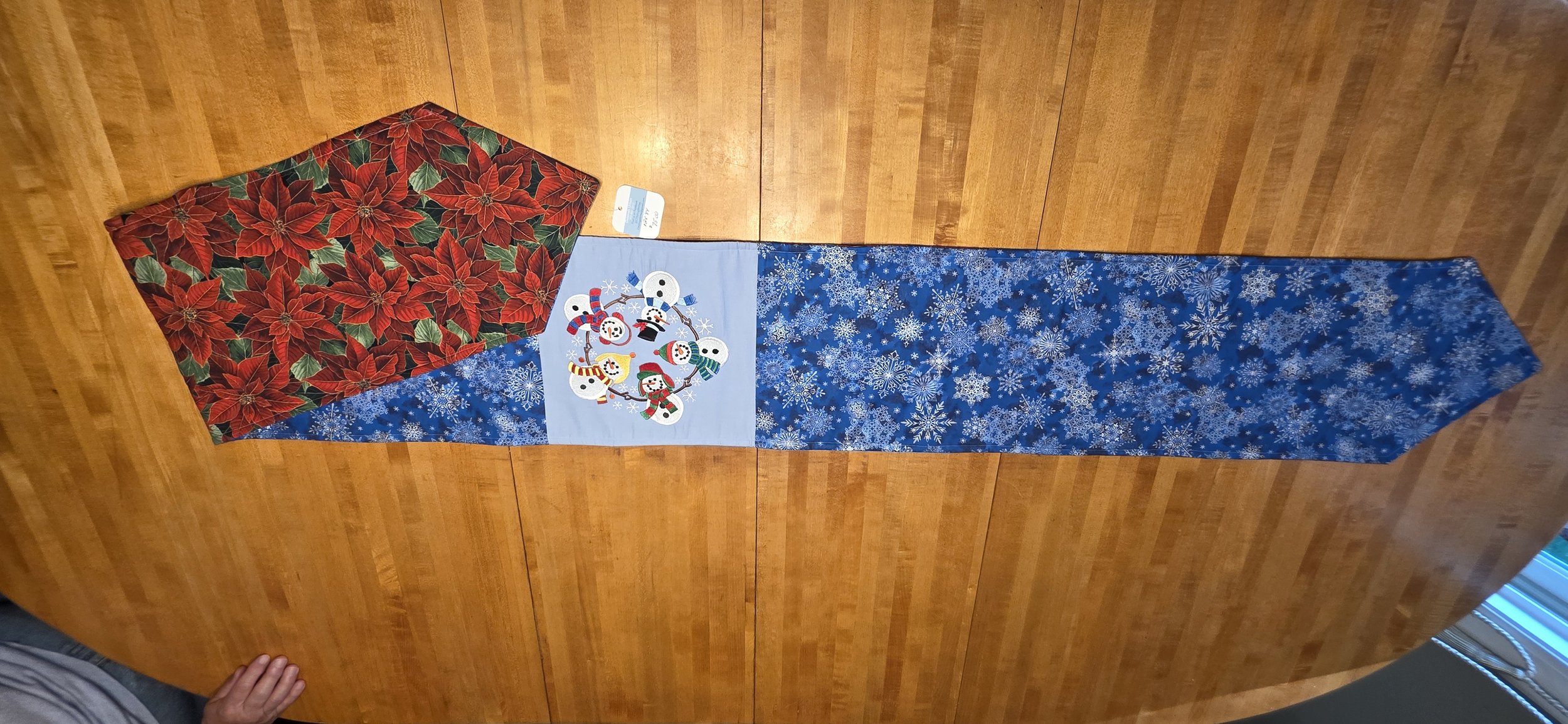 Embroidered snowman in a cirlcle holding hands with pointsetta on reverse side one of a kind 12"x84"