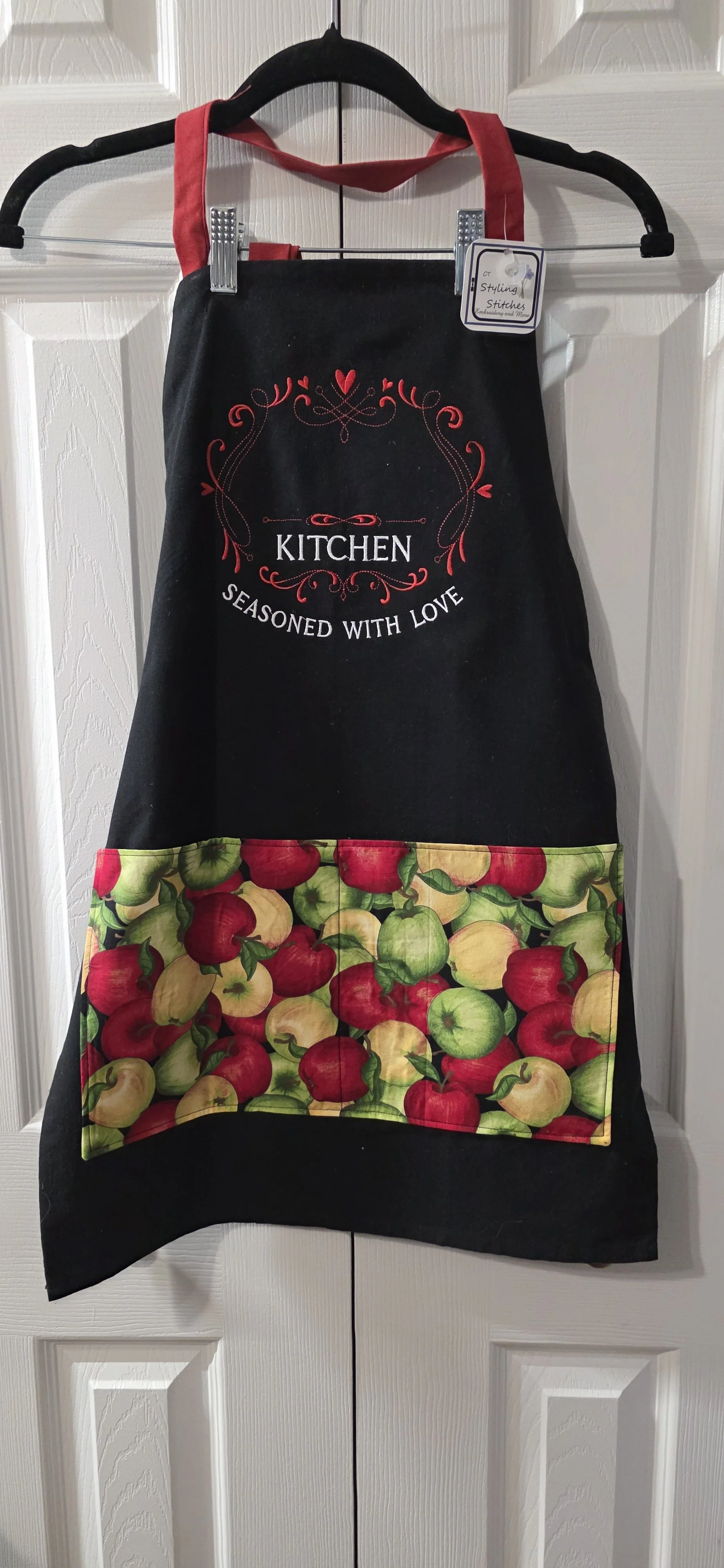 Adjustable  balck tea towel apron with apple cloth pocket.  Personalize this at an additional cost