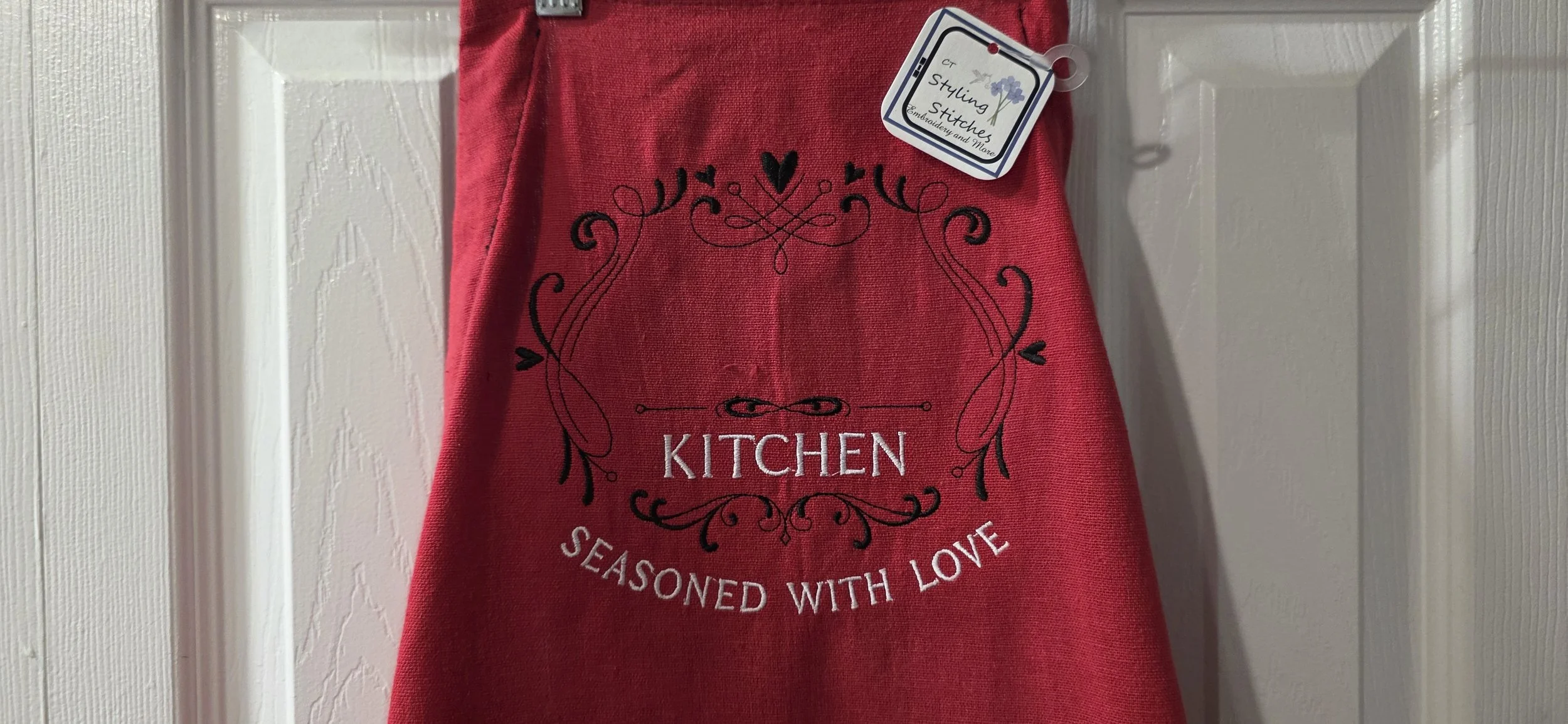 Adjustable tea towel apron red with BBQ cloth pocket. Customize with a name at an additional cost.