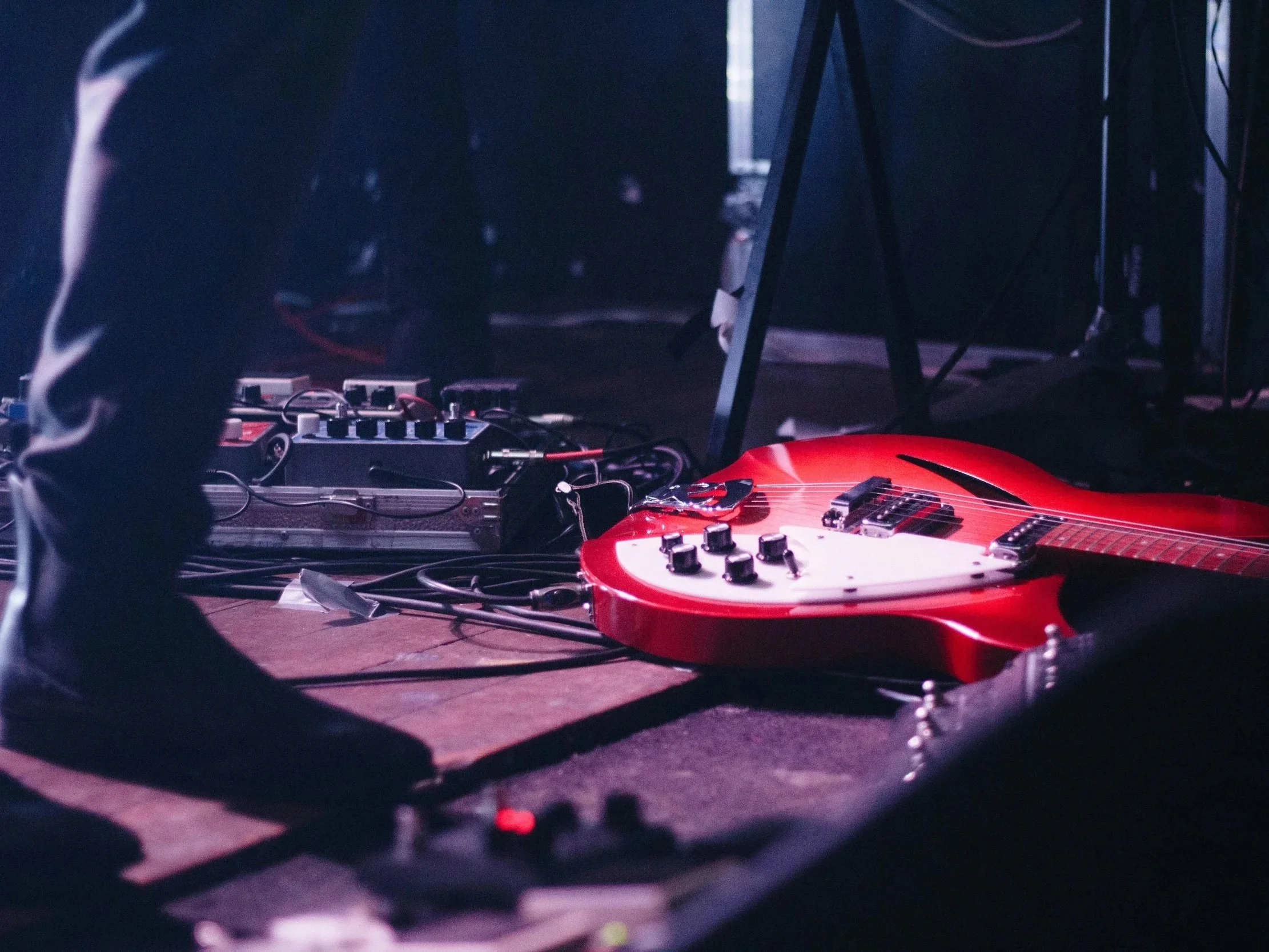 Red guitar on stage at concert.
