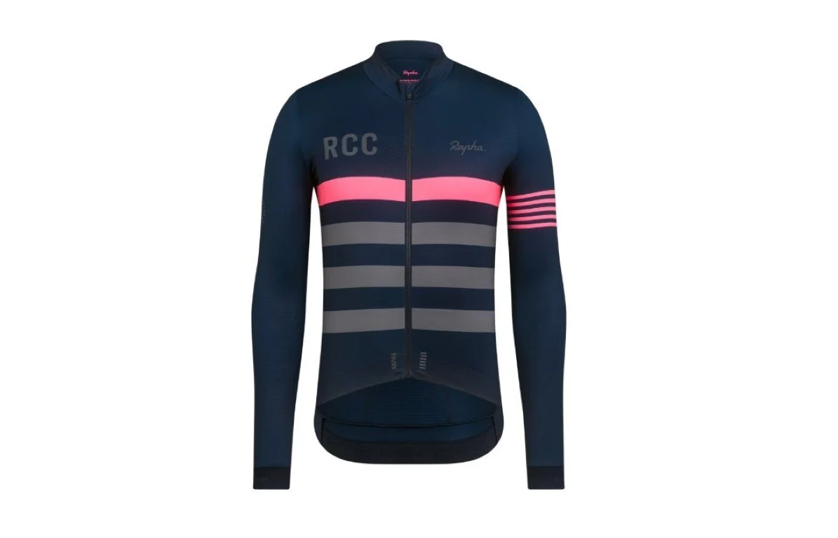 A navy blue cycling jacket with a front zipper, pink and gray horizontal stripes, and the letters "RCC" and the brand name "Rapha" on it.