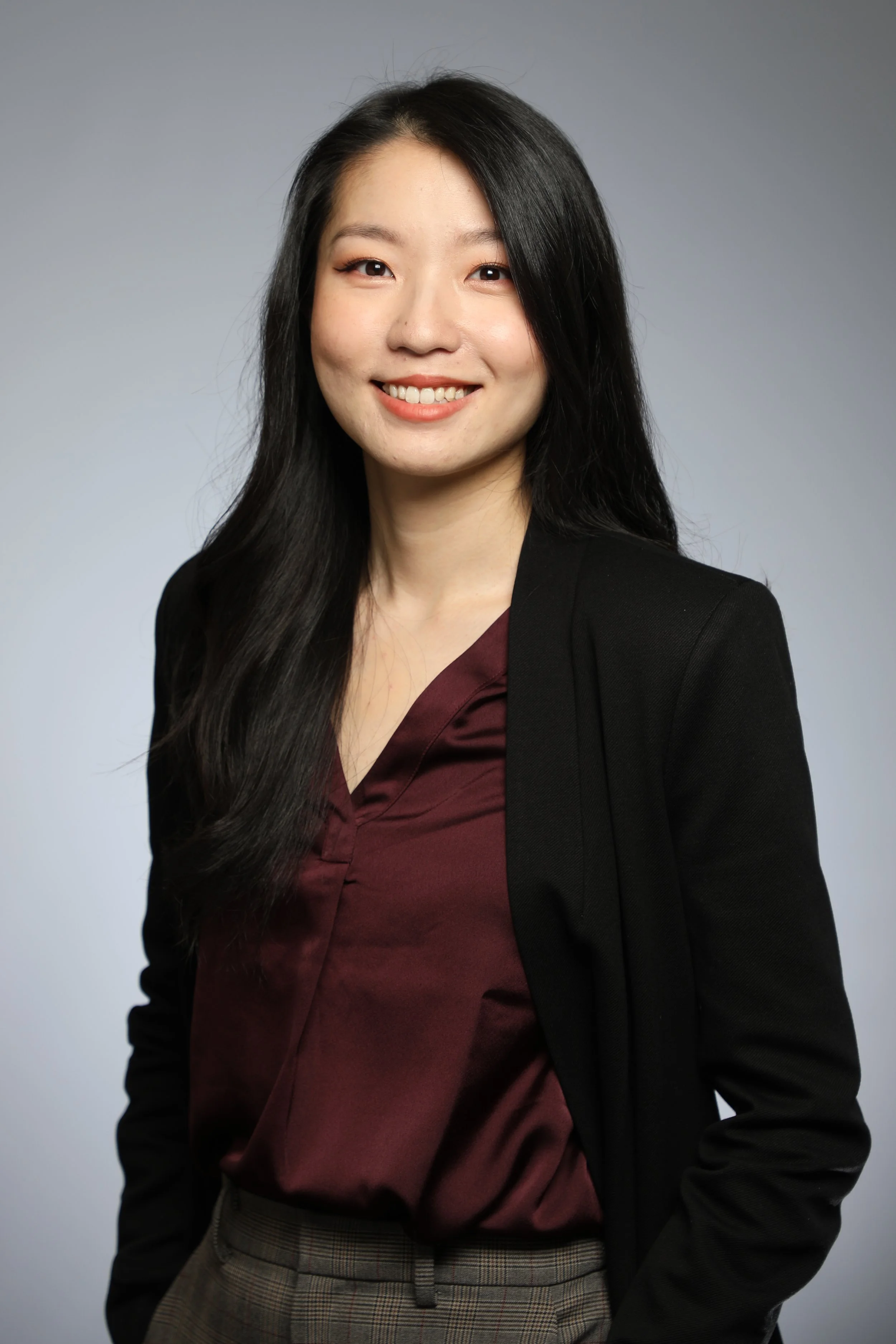 Headshot of Eungenia in a dark red top with a black blazer