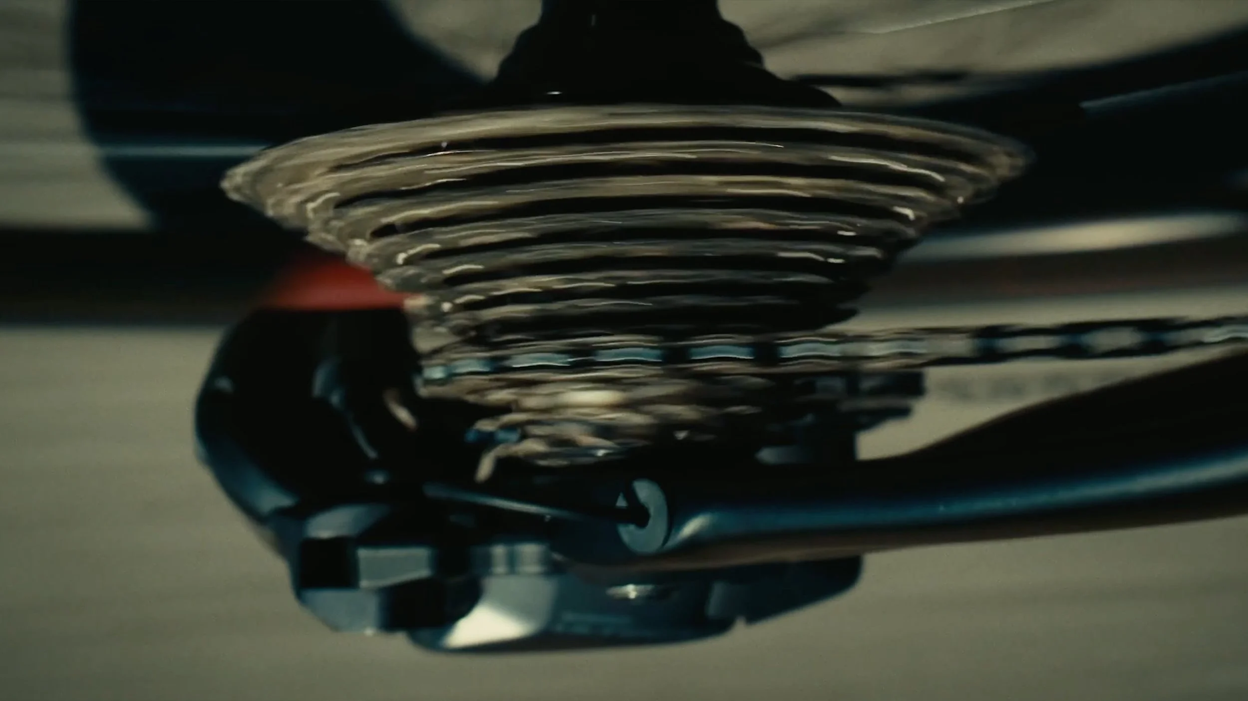 Close-up of a motorcycle engine's cooling fin and exhaust pipe.