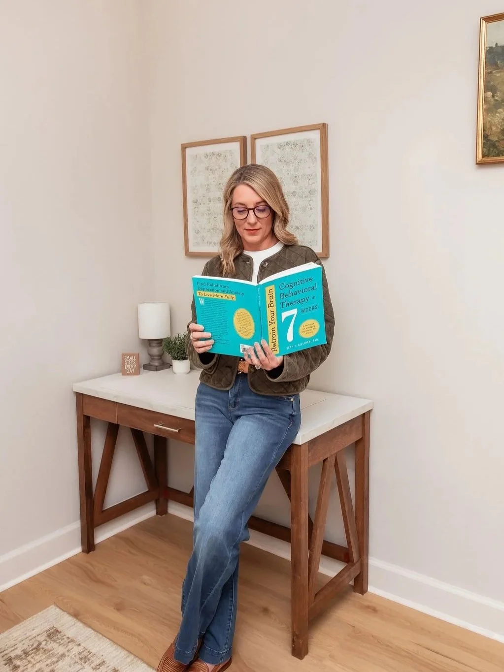 Angie Sticker, LPC, reviewing a therapy resource at Bramblewood Counseling and Wellness in Katy TX