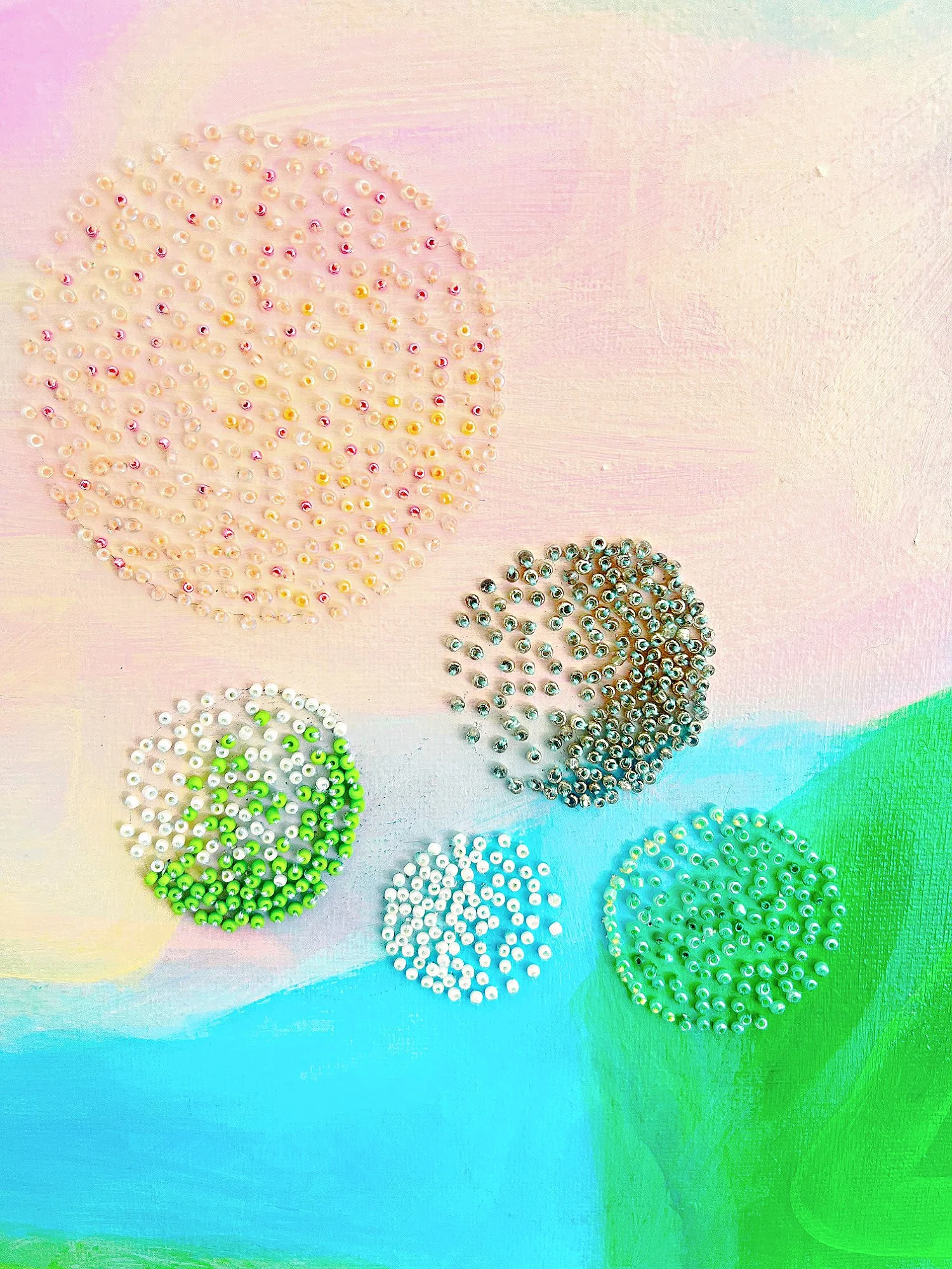 Abstract landscape with blues and pinks featuring beadwork