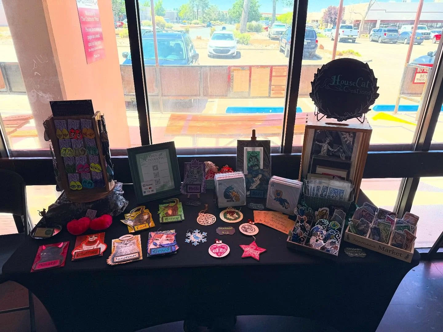 All set up with the @abqfosterkittencoalition and a bunch of great vendors at @the_craftroom_nm for the cat adoption event! I decided to just bring my cat themed art and - shocking no one - that was still enough to fill a 6&rsquo; table 😹 I WAS BORN