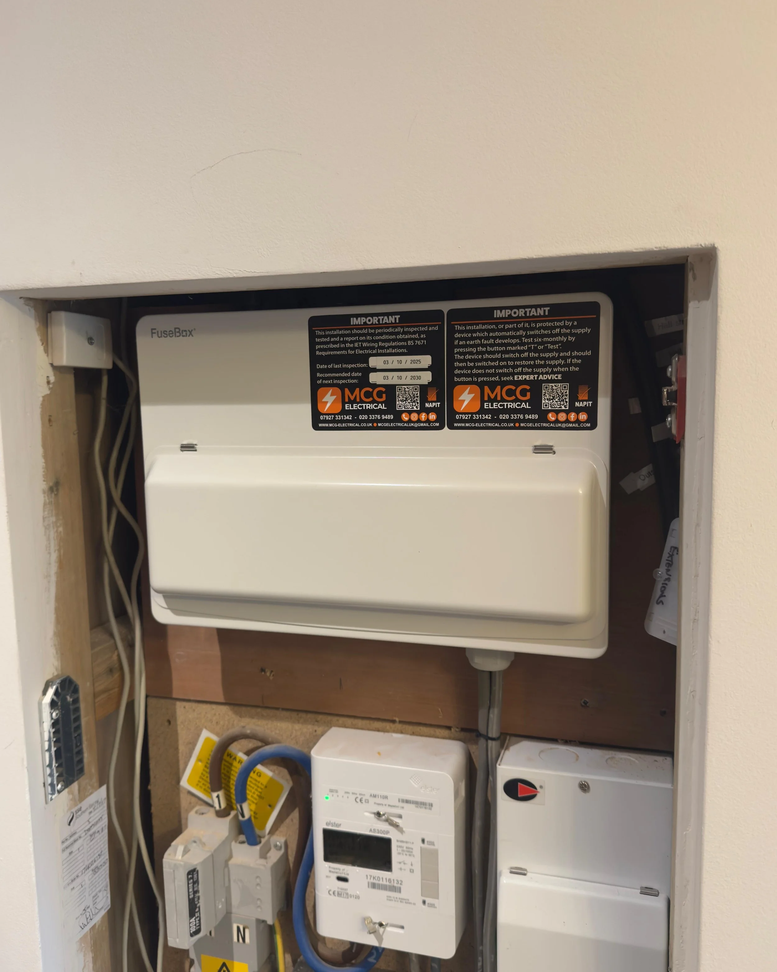 Electrical fuse box and outlets mounted on a concrete wall