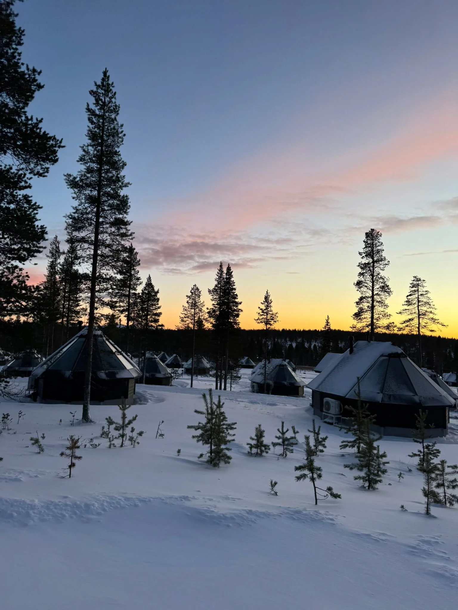 Aurora cabins under a pink sky, Northern Lights Village, Saariselka