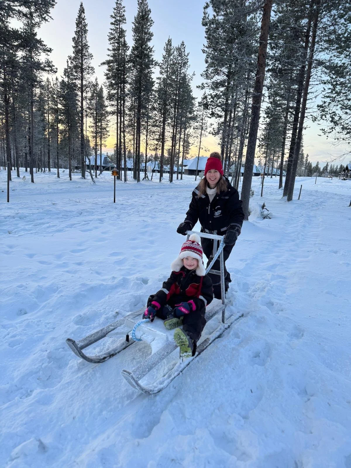 Pushing kids on sledge, Northern Lights village, saariselka