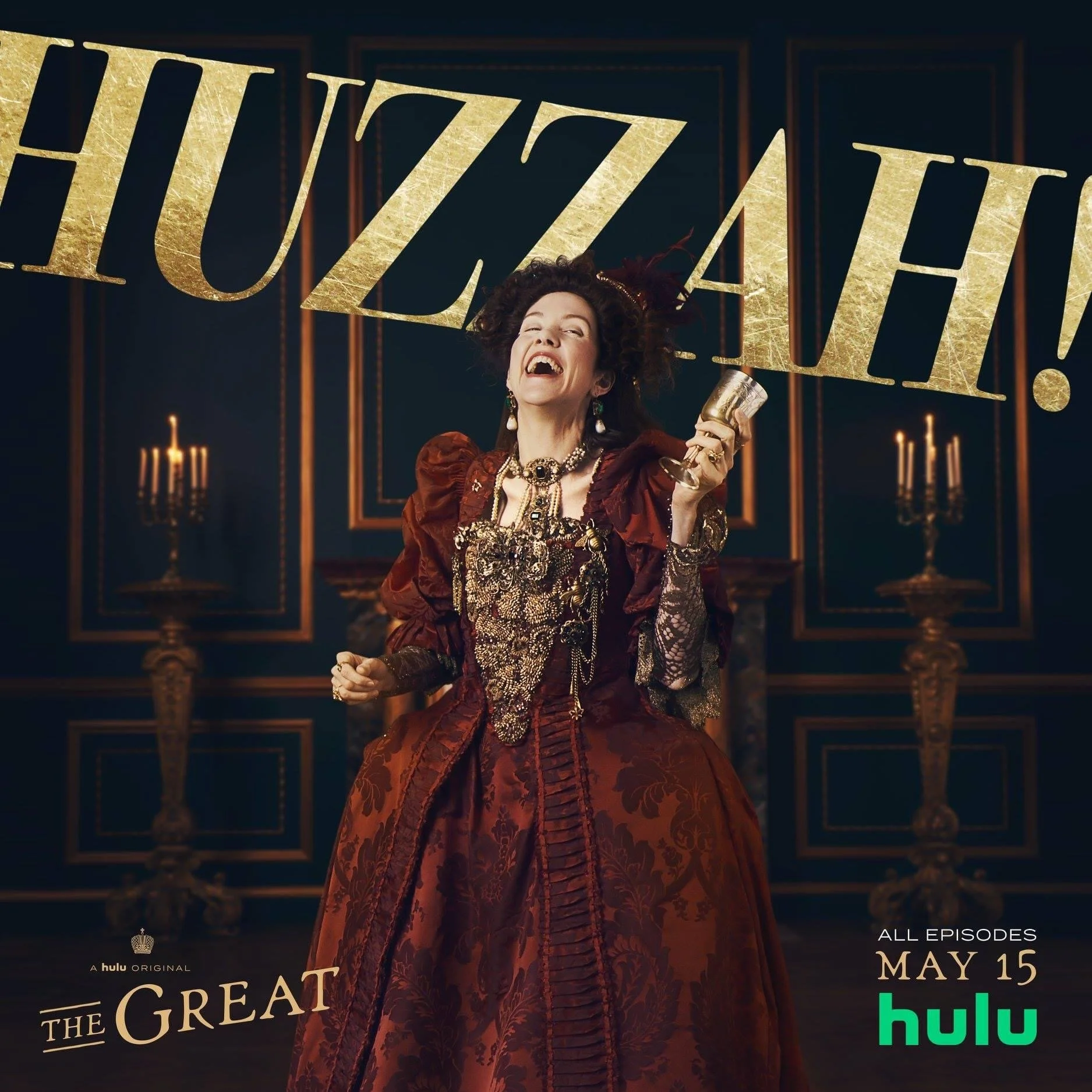 A promotional image for the Hulu series "The Great" featuring a character in elaborate period clothing holding a cup and laughing with the word "HUZZAH!" in large letters. The series is set to premiere on May 15.