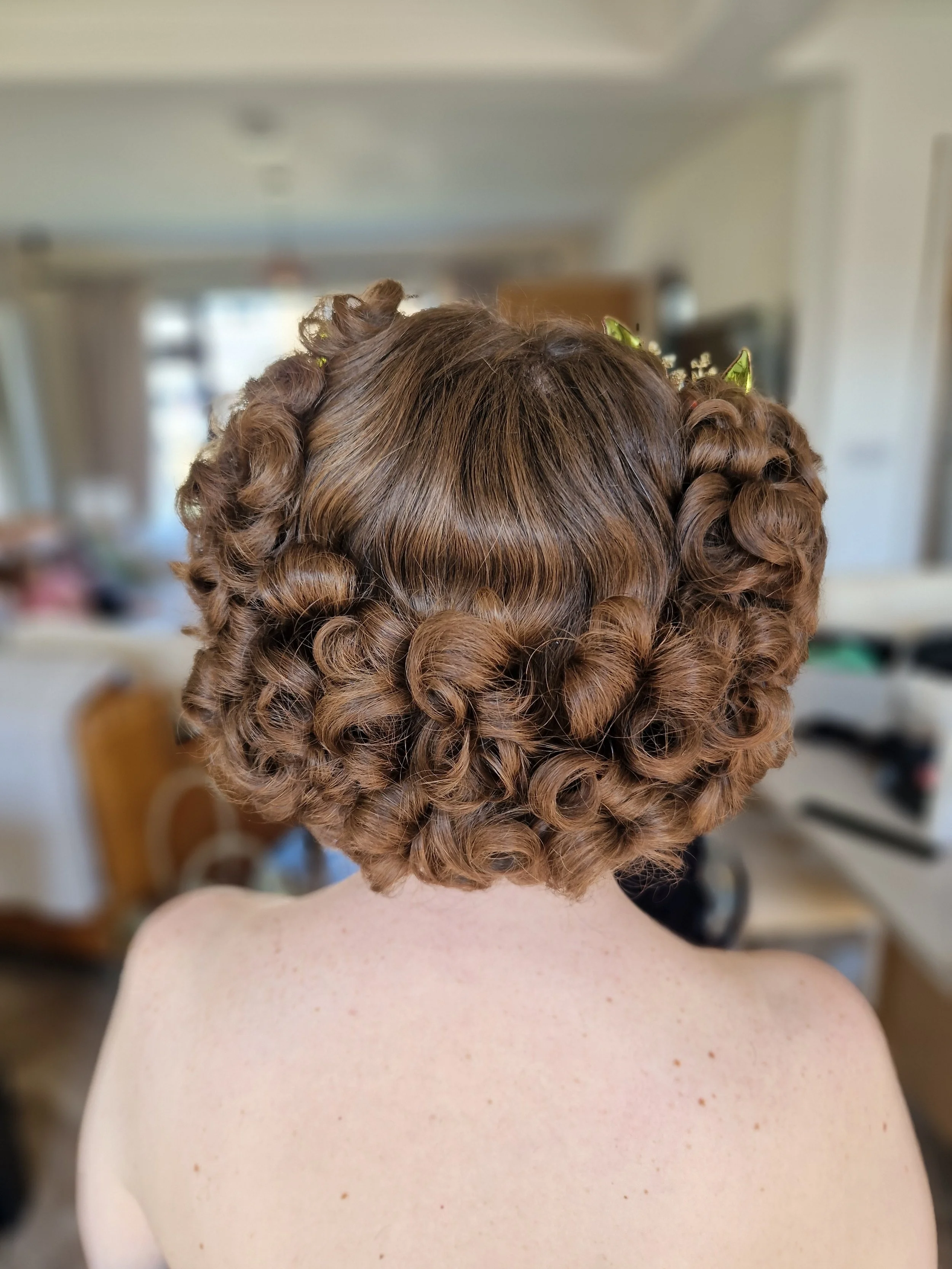 Bride smiling wearing white lace wedding dress and diamond accessories