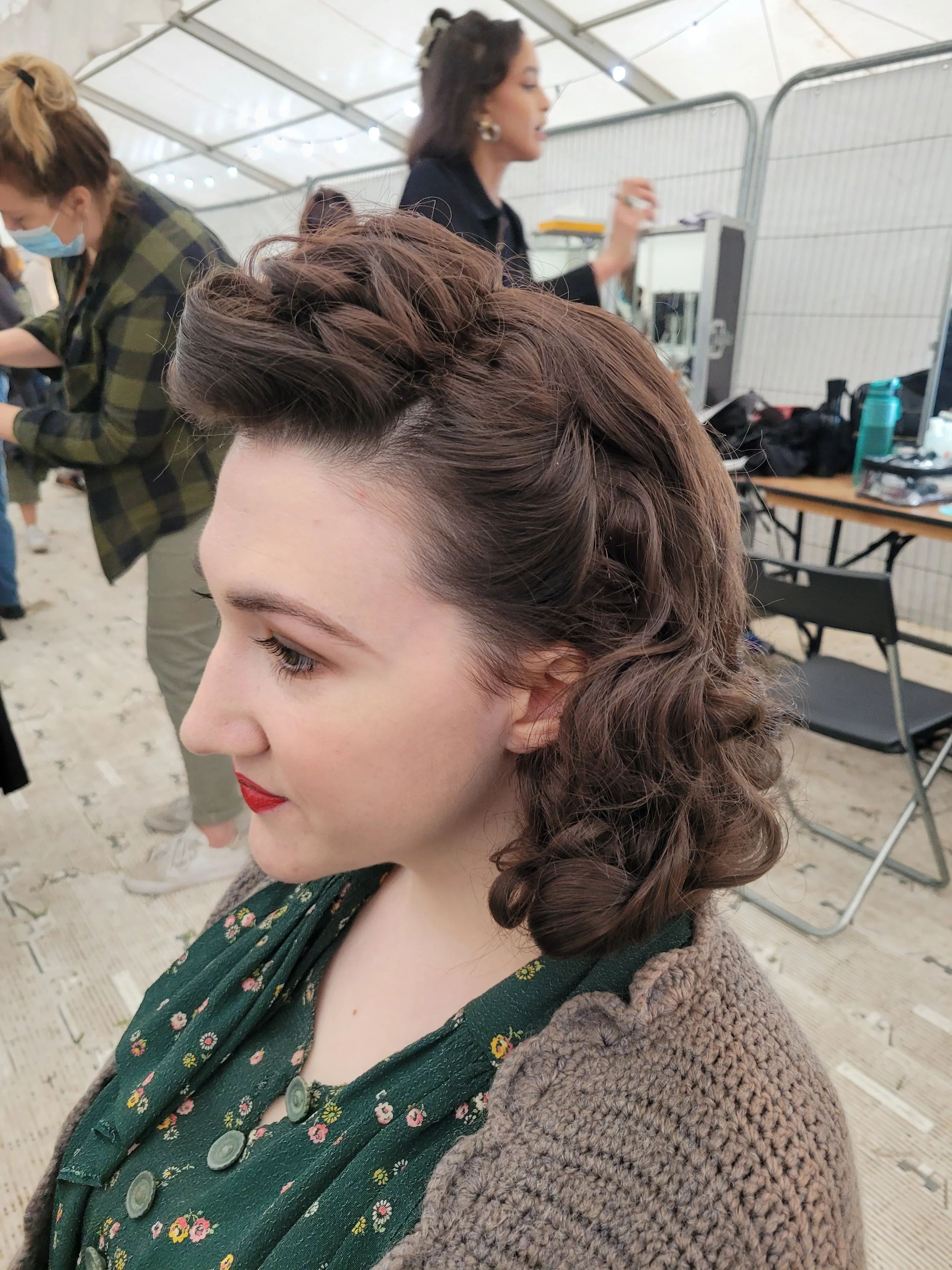 Woman with vintage hairstyle and red lipstick in a stylist workshop