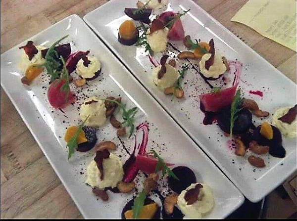 Gourmet salad plates with beets, creamy dollops, greens, nuts, and sauce.