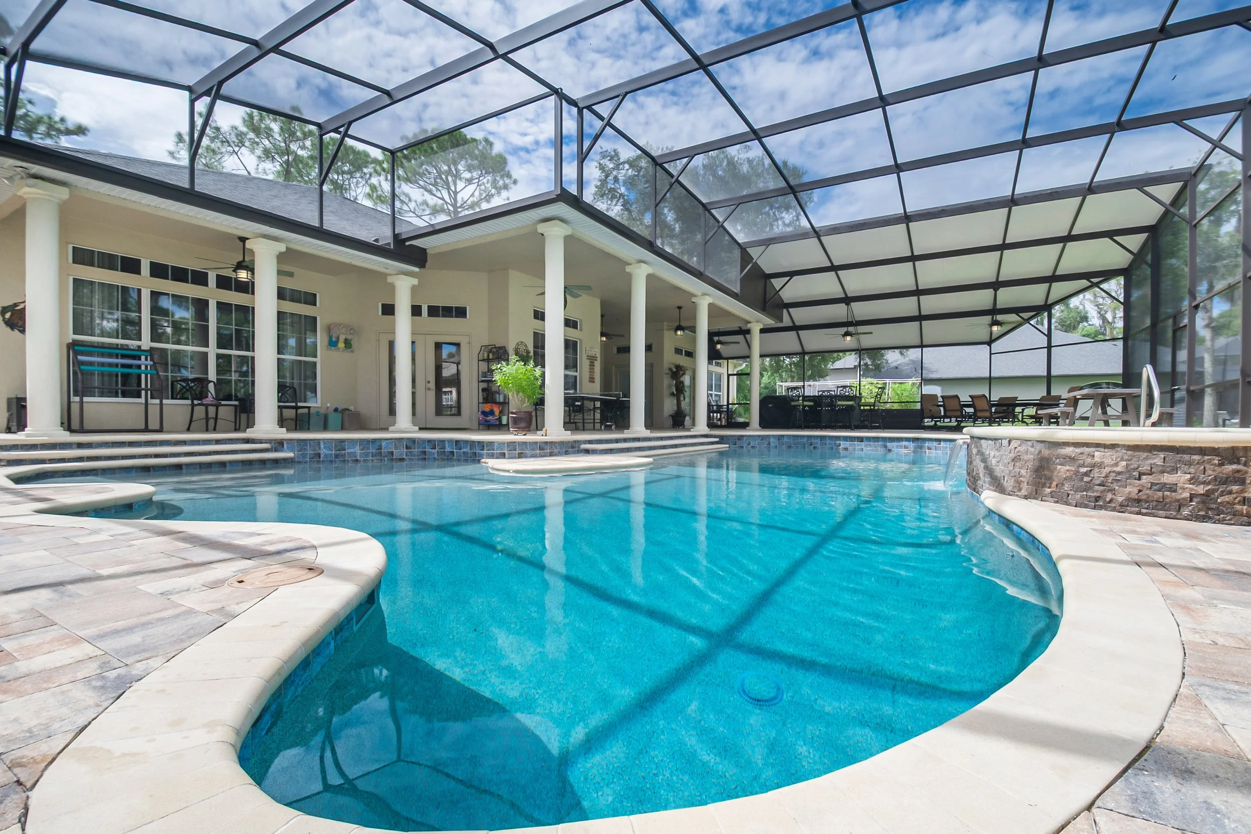 Beach Entry Pool and Oversized Spa with Natural Stone Facade