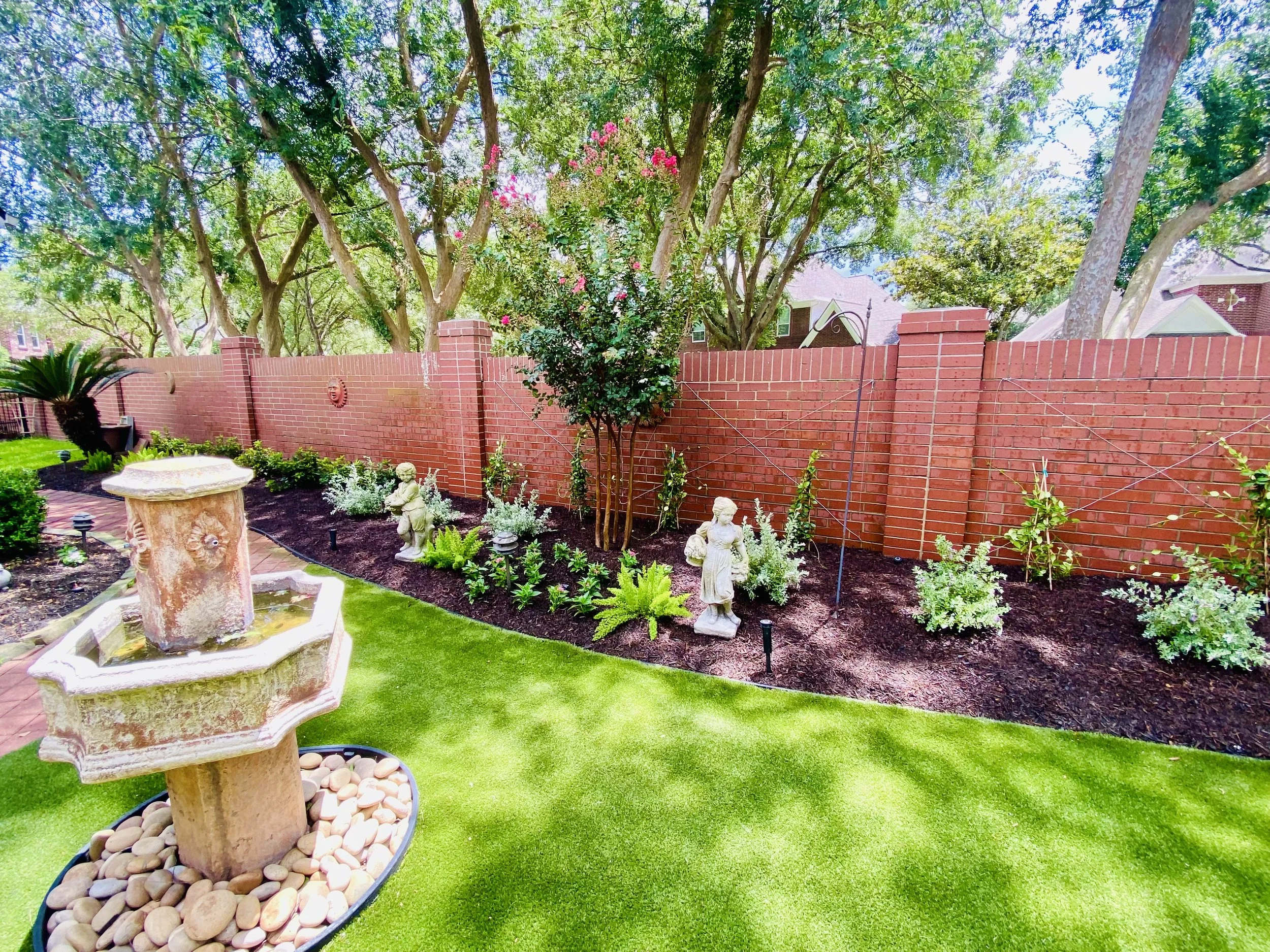 Reimagined Sugar Land backyard with trimmed beds, structured layout, and healthy new plantings
