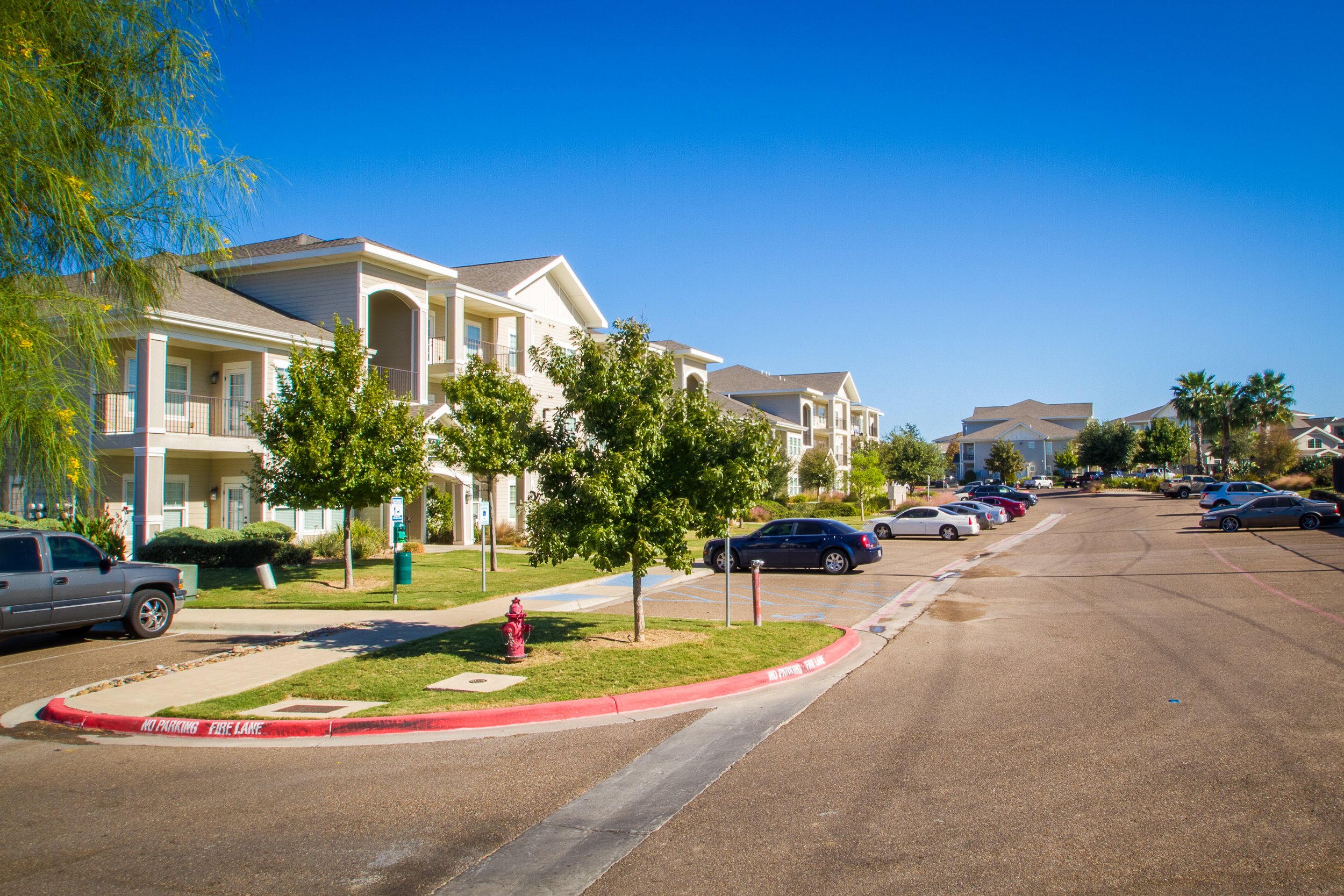 Side-angle exterior of Dorel Apartments in Laredo, Texas, showcasing a large-scale apartment complex built for durability, accessibility, and community living.