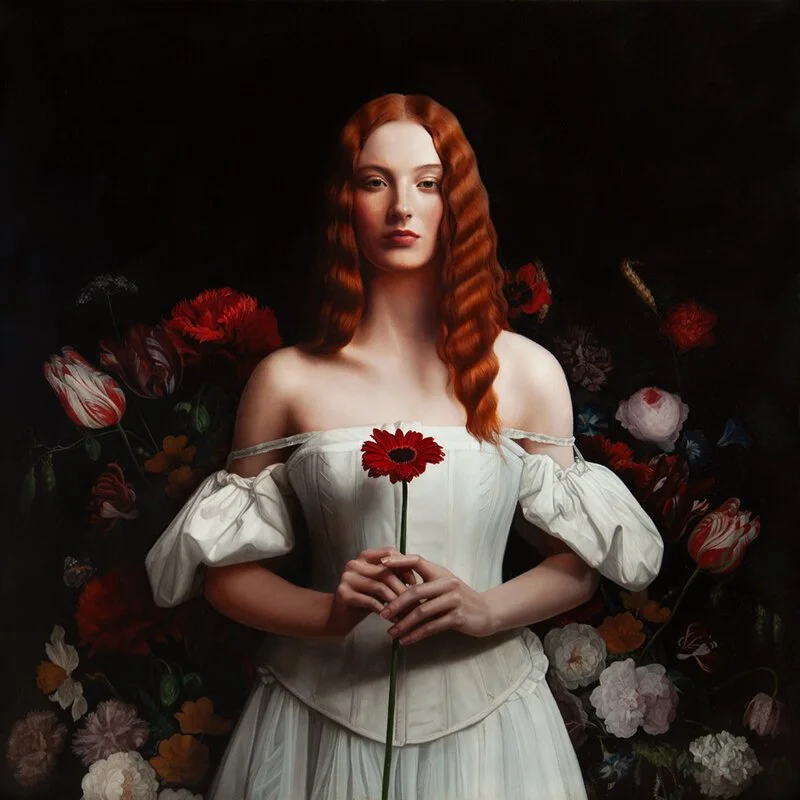 A woman with long, wavy red hair, wearing a vintage white dress, holding a red flower, surrounded by colorful flowers against a dark background.