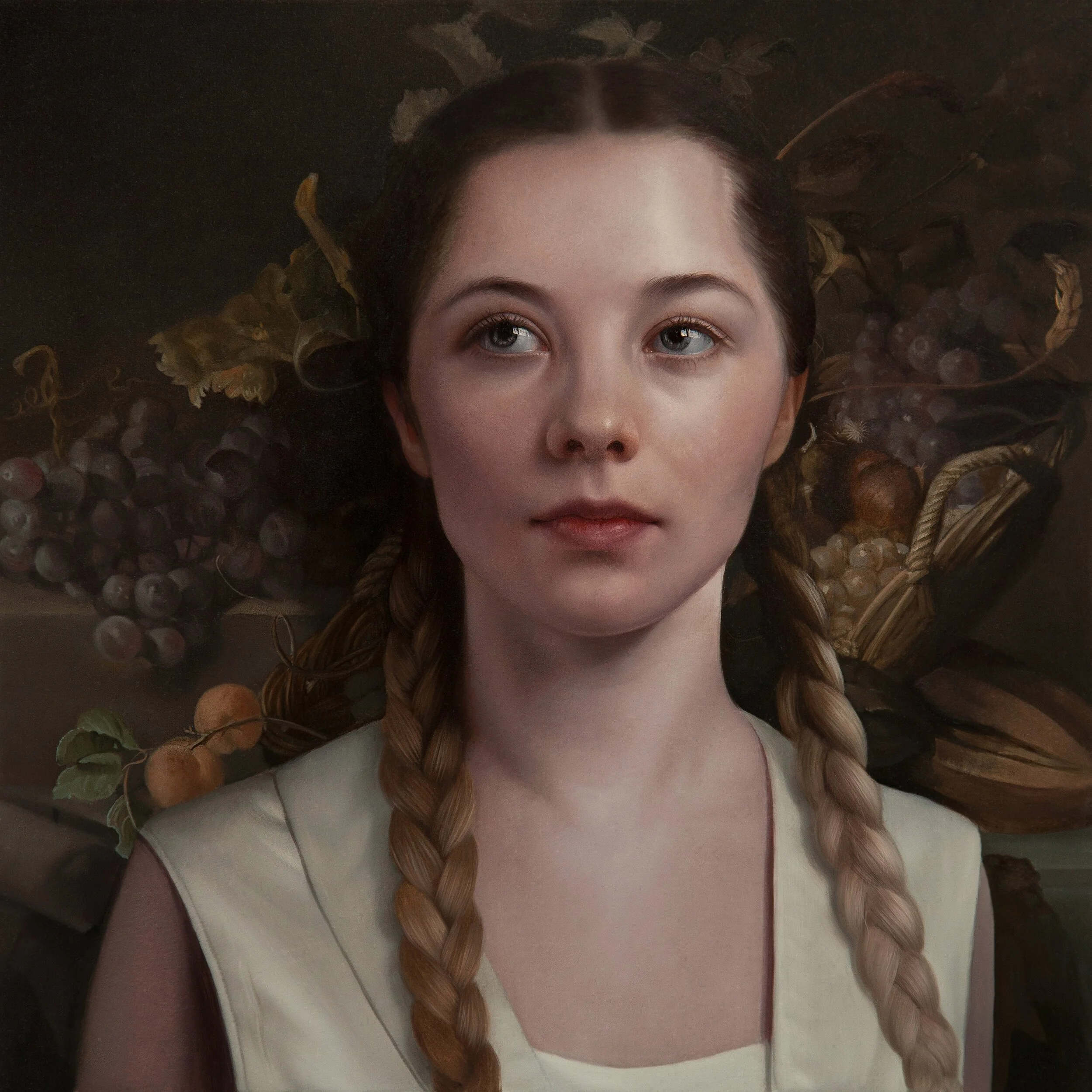 A young woman with braided hair, wearing a cream-colored top, standing in front of a dark background with still life elements including grapes, leaves, and basket.