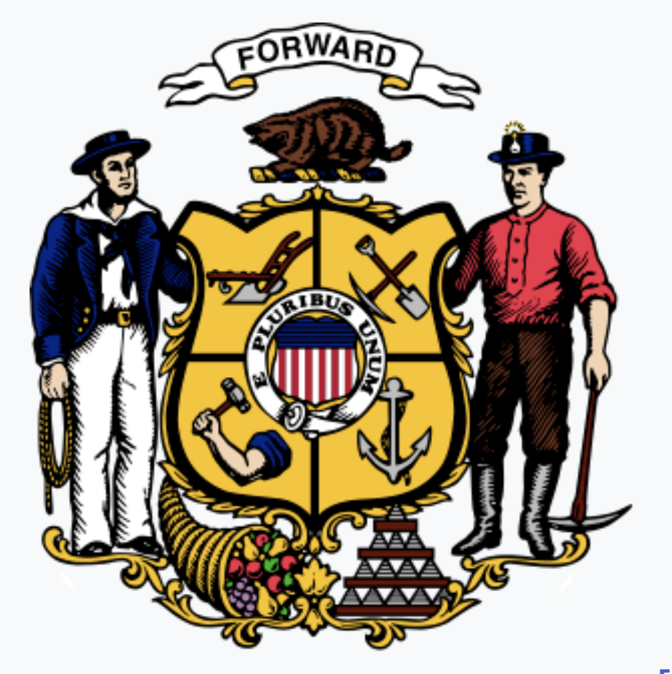 The image depicts the official emblem of the state of Massachusetts featuring a shield with symbols like a plow, arm with a muskett, anchor, and a star. Surrounding the shield are a Native American with a bow on the left and a man in colonial attire with a sickle on the right. Above the shield is a banner with the word "Forward" and a wildcat at the top. Below the shield is a bundle of wheat, grapes, and a pyramid-shaped structure.
