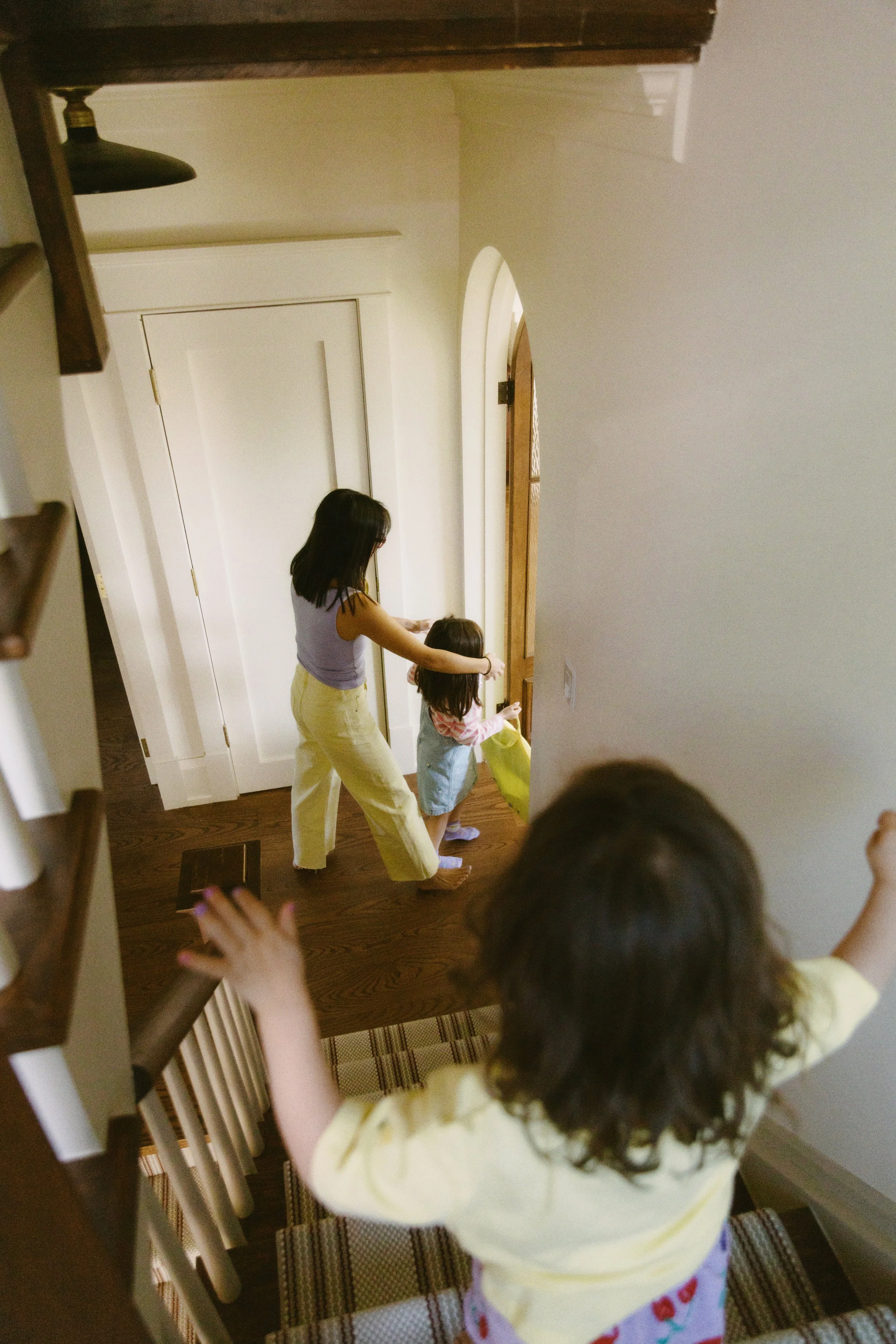 Storytelling family photograph of children moving through their home during an in-home family session.
