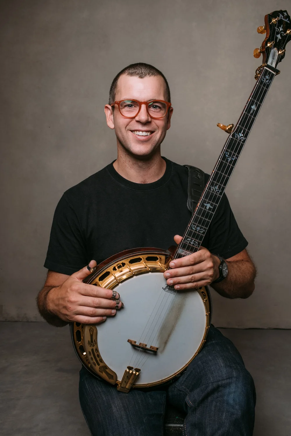 Bennett Sullivan holding a five-string bluegrass banjo