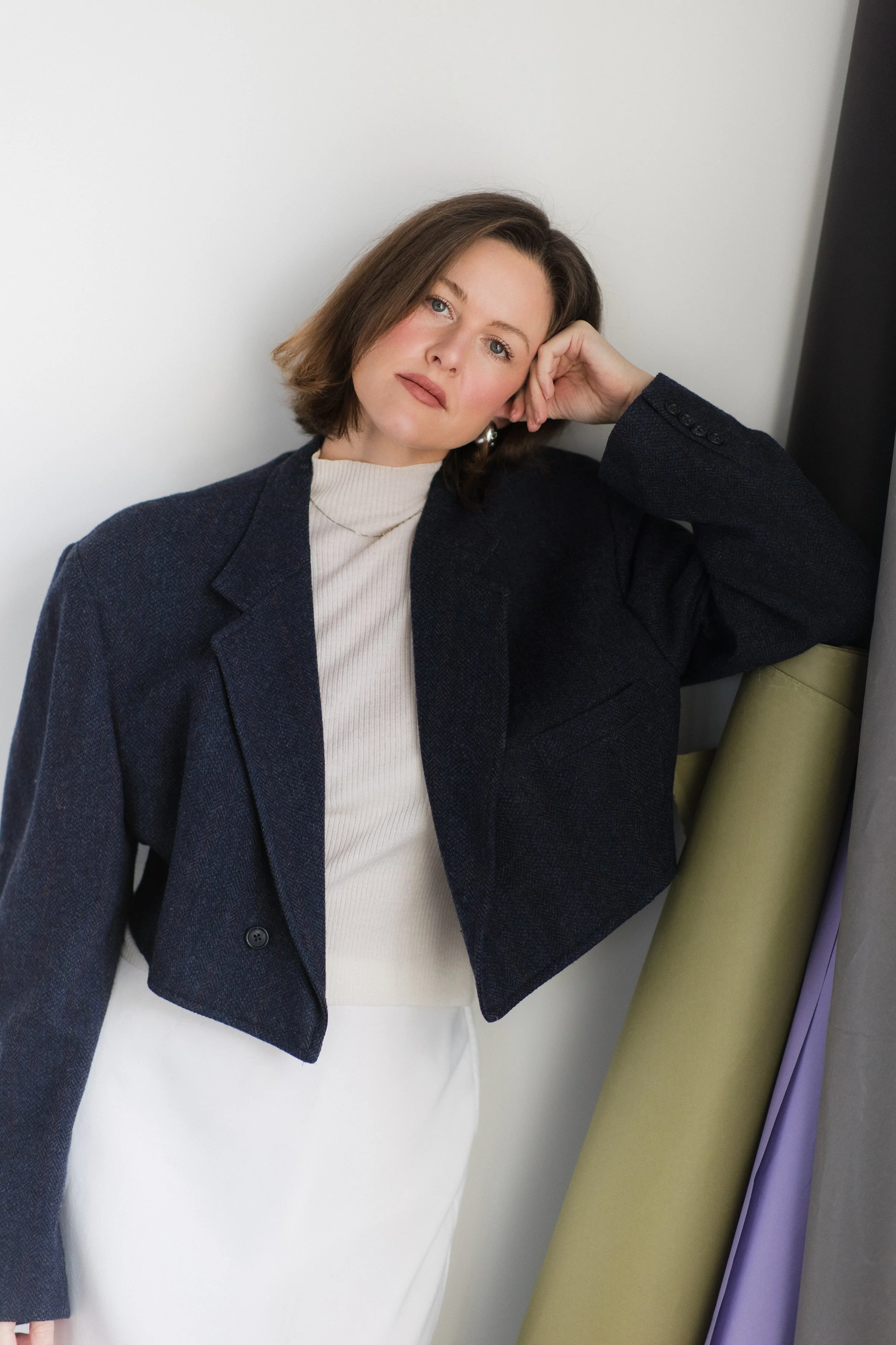 Woman leaning against paper backdrops for branding photos