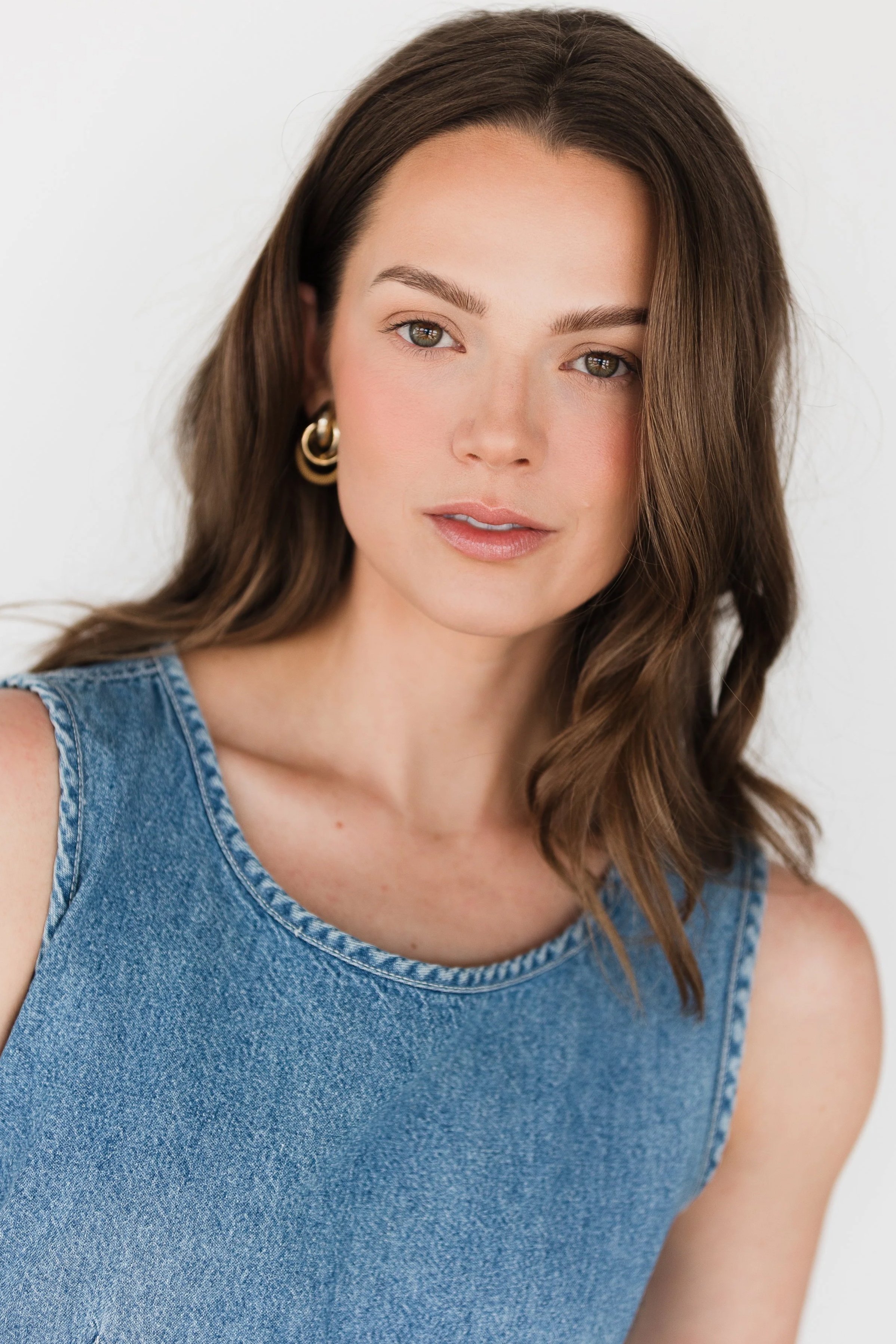 A modern portrait of a woman looking at camera in a natural light photography studio in northern michigan