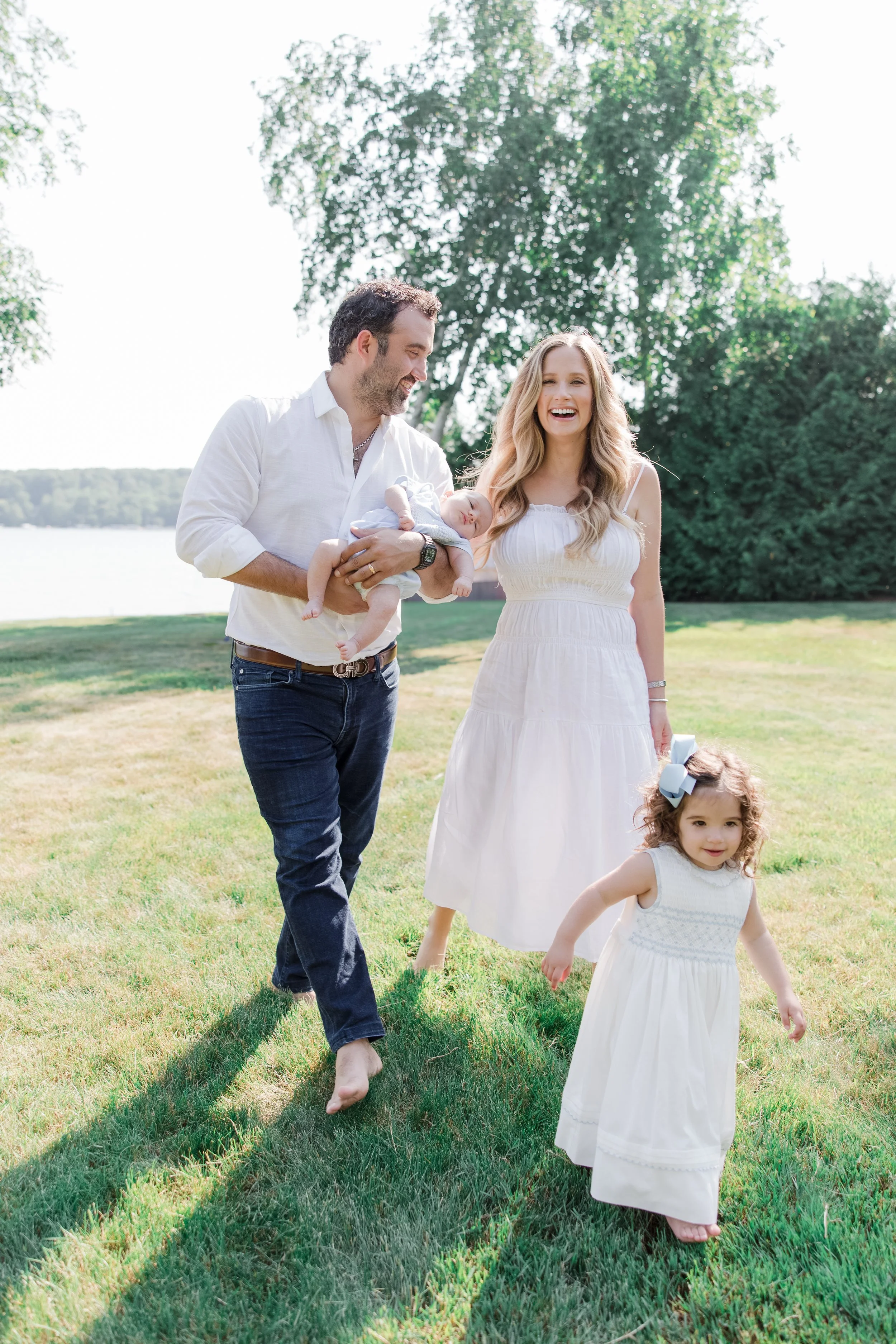 Photo of a family laughing and walking in their yard in northern michigan