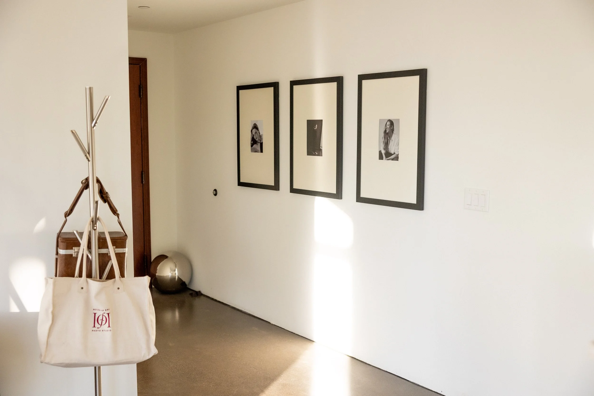 Framed portraits in photography studio hanging on wall in entryway in traverse city michigan