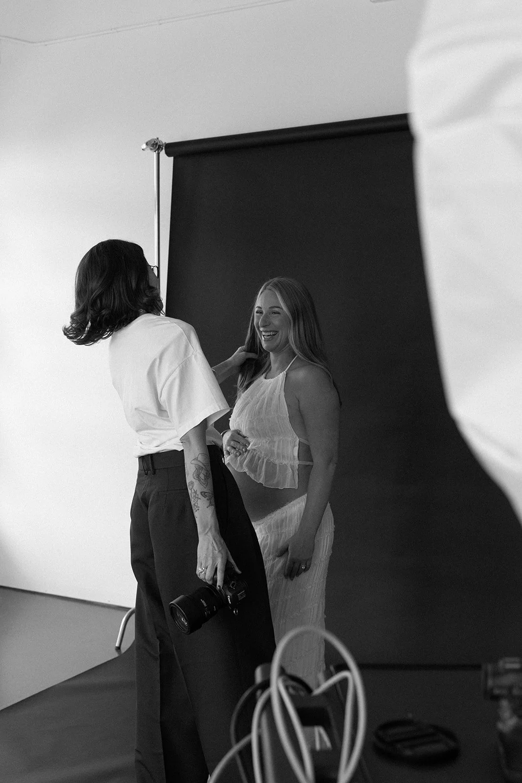 A photo of a female photographer at her desk smiling in her photography studio