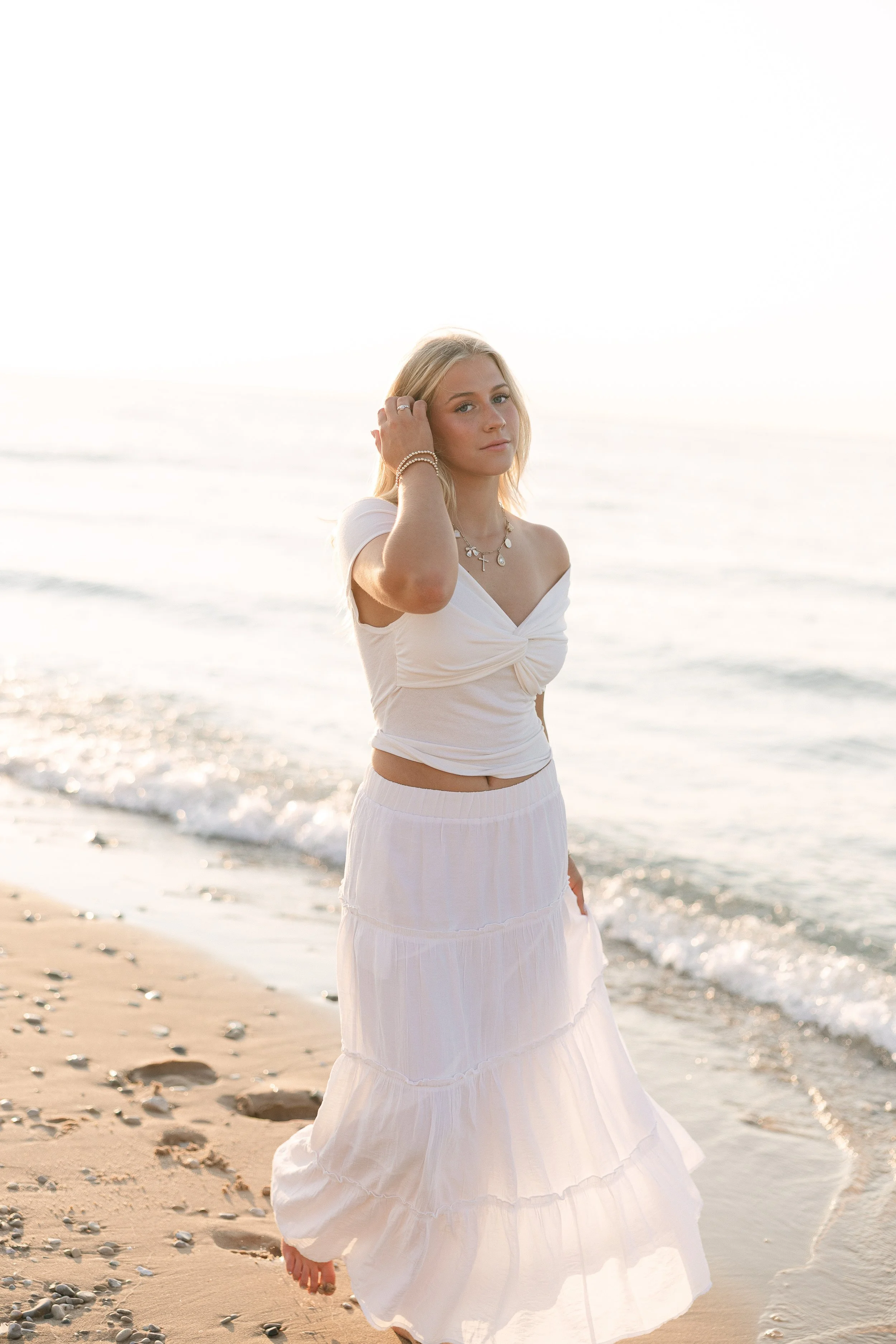 A portrait of a female senior at golden hour in traverse city Michigan