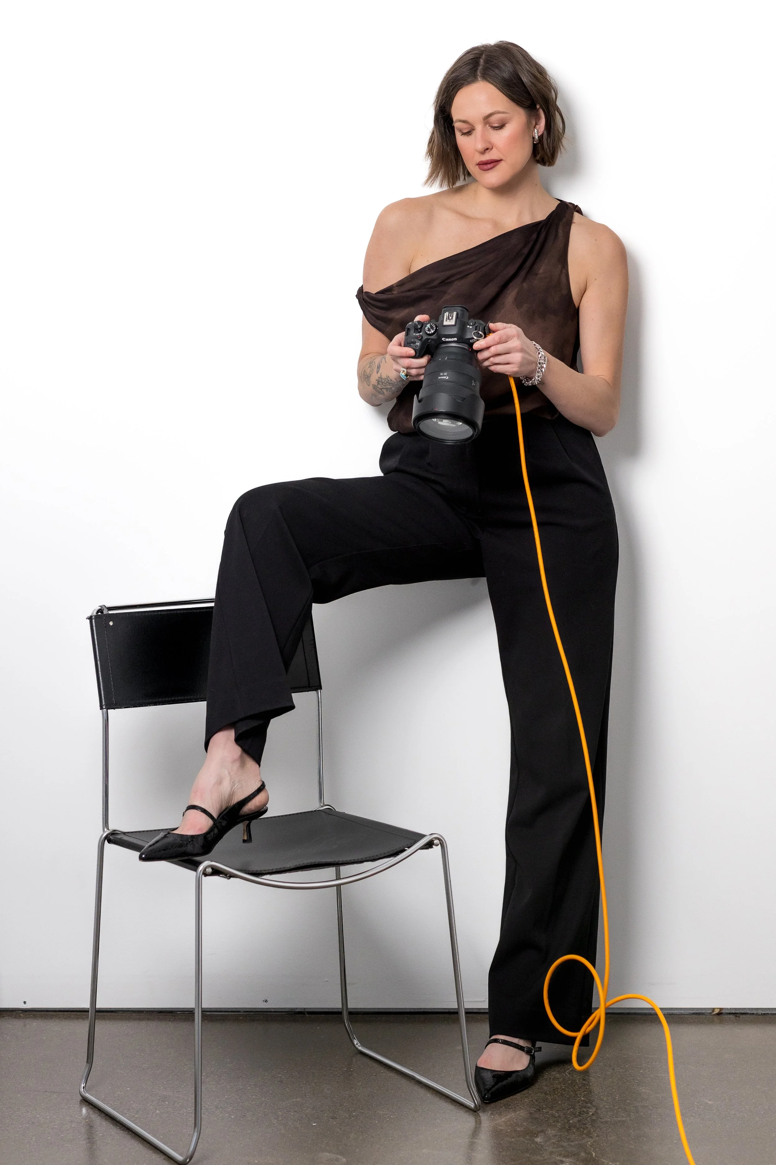 Women founder holding camera in a photography studio