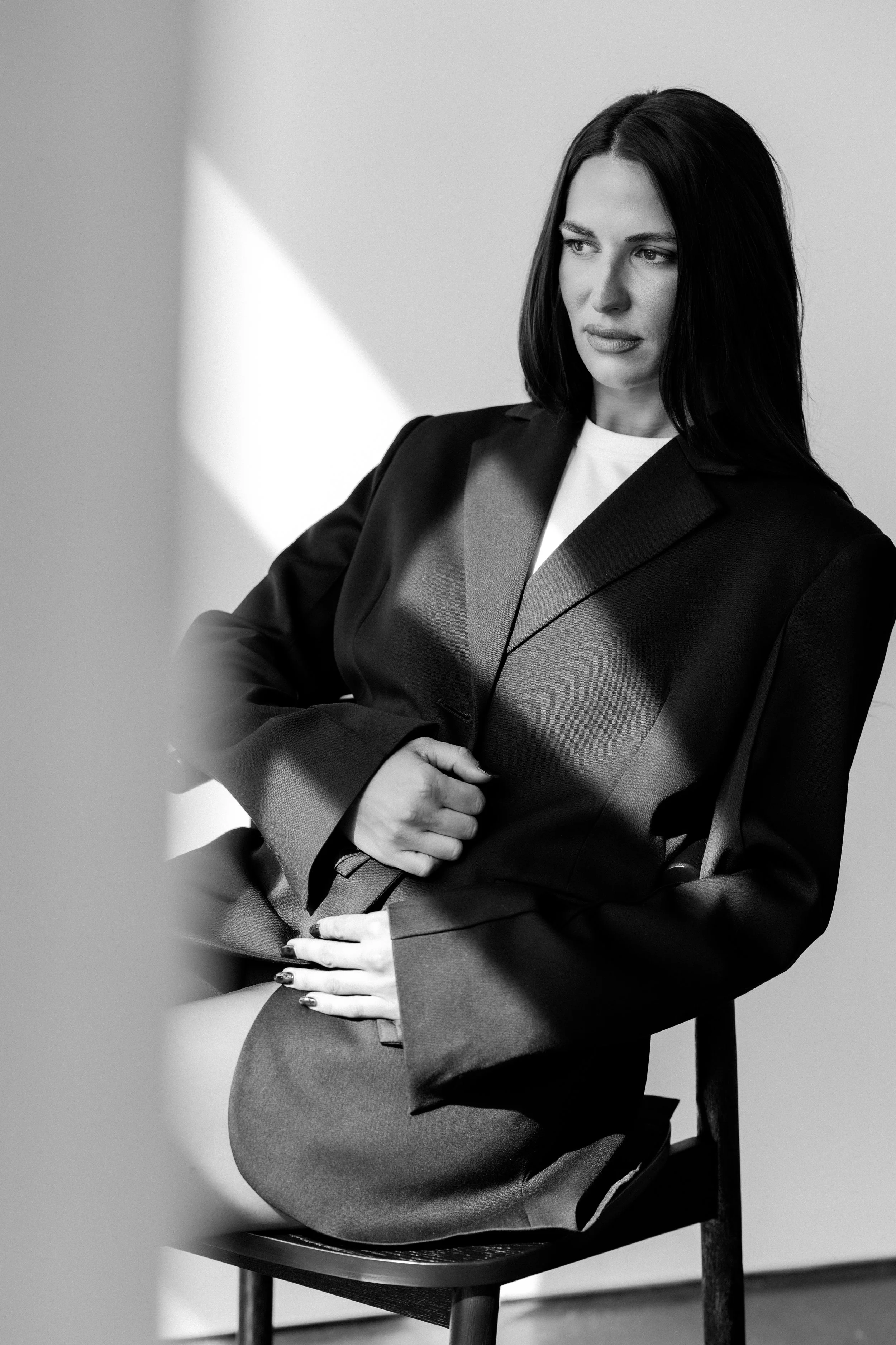 A women being photographed in a black blazer for her branding photoshoot