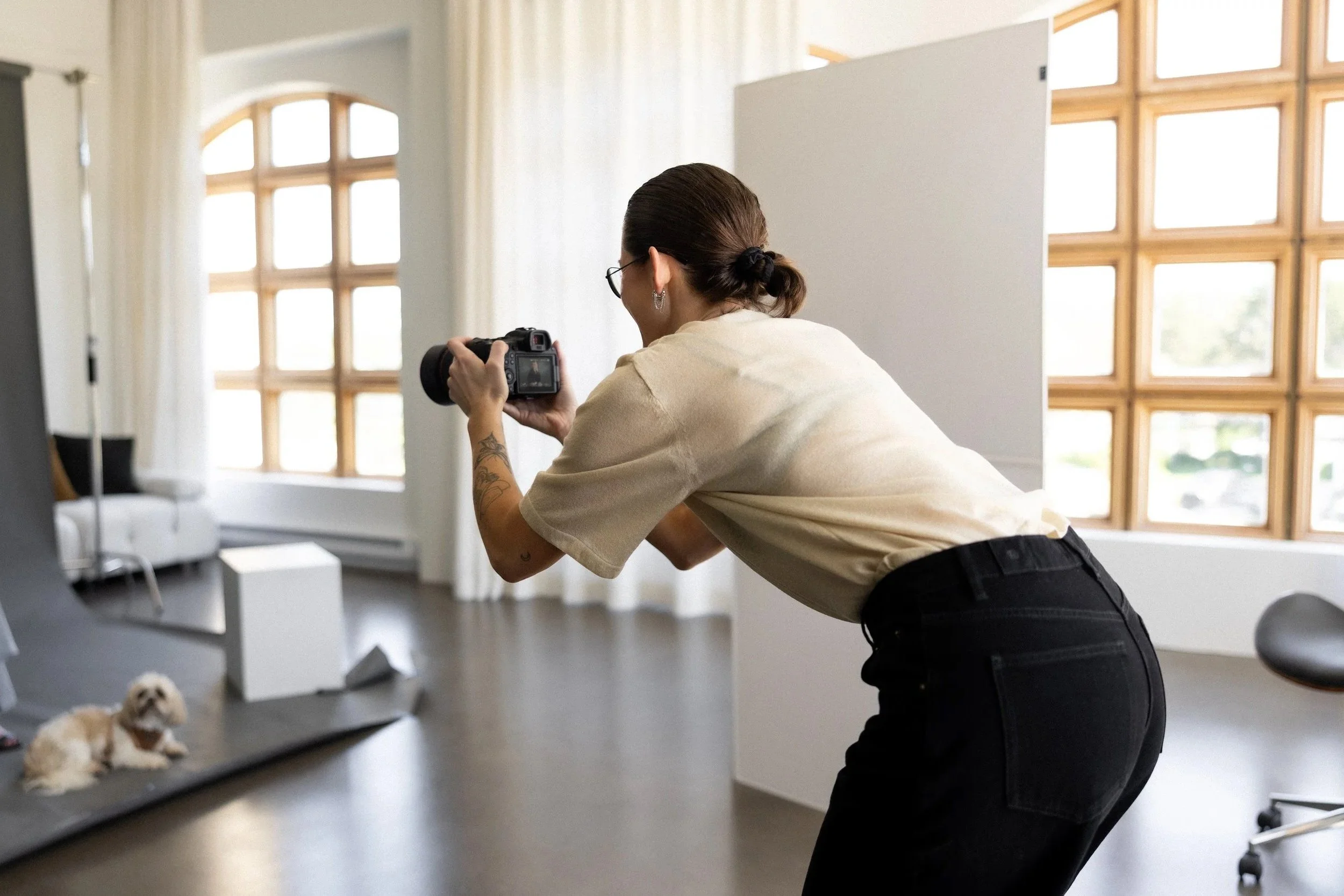 Image of woman holding a camera during a photoshoot at Traverse City studio