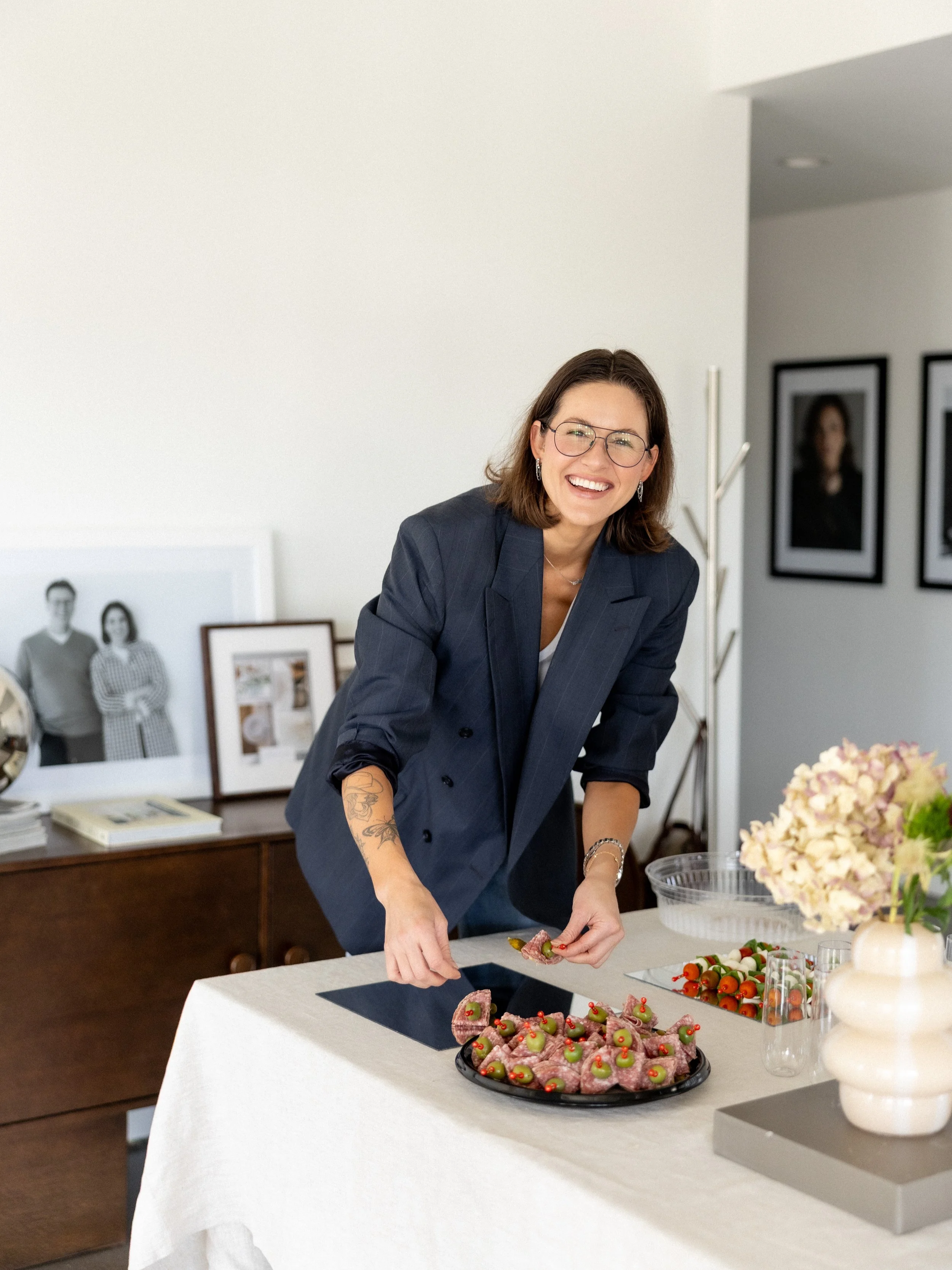 Image of women displaying food on a table for event at studio