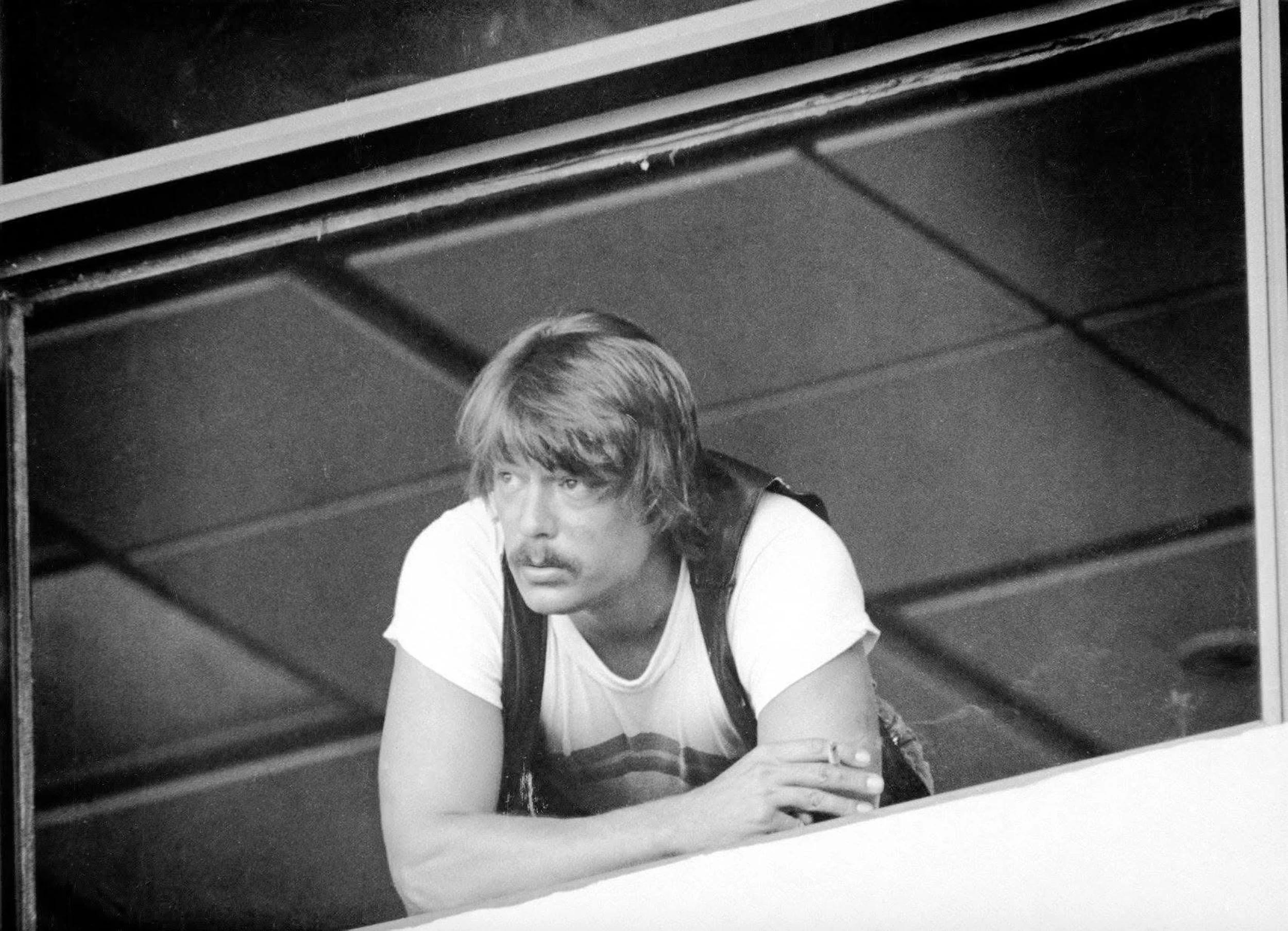 Rockne Krebs, 1975, St. Petersburg, FL. during the installation of his laser sculpture on The Pier. Photo by Bill Tyjewski of Rockne as he watches as a 1,000-pound steel laser table is lifted through the window.